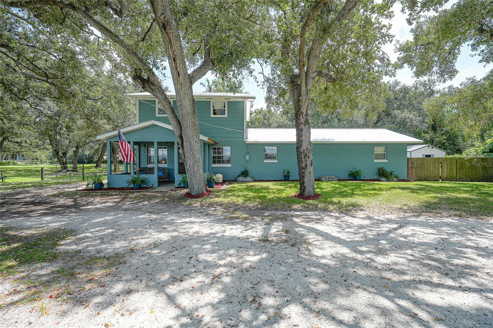 If you’re dreaming of space, fresh air, and a home that just feels right, this two-story beauty is ready to make it happen. With three bedrooms, two and a half bathrooms, and the primary suite tucked perfectly on the main floor, it’s set up for everyday comfort and easy living. The kitchen is light, fresh, and updated with a trendy backsplash, modern finishes, and double doors that open right up to your own outdoor escape. The dining room flows perfectly between the kitchen and living room, making it easy to keep everyone connected whether it’s a weeknight dinner or a Saturday get-together. Guests will love having a conveniently placed half bath right in the main living area. The primary suite is its own little retreat with a walk-in closet and a bathroom designed for real relaxation. You’ll have both a walk-in shower and a soaking tub big enough to make you cancel your weekend spa plans. This home has been meticulously maintained and has so many windows that every room is drenched in natural light. Sitting on over an acre, the property is fenced in the back and ready for picnics, s’mores around the firepit, or just enjoying the peace and quiet of your own slice of the world. The landscaping is immaculate, and the trees here aren’t just trees. They’re the kind you sit under with your favorite drink and never want to leave. Life here looks like dinner on the patio with the sun setting through the branches and every day ending with that deep breath you only get when home actually feels like home. Located near everything we love about Arcadia, this needs to be at the top of your list to see!