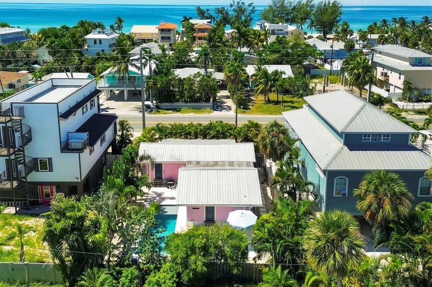 Step onto the spacious screened front porch, now featuring Timber Tech by Azek Porch Collection decking, framed by original Pecky Cypress siding, and enjoy the timeless charm of this lovingly restored 1940s 2 bed / 2 bath craftsman beach cottage just steps from the Gulf. This home blends Old Florida character with today’s comfort. Inside, new shiplap walls pair with Daltile’s Asher Bend luxury vinyl flooring in a herringbone pattern over a brand-new subfloor. This waterproof, scratch resistant surface combines the warmth of wood with the resilient vinyl, perfect for beachside living. The open kitchen boasts custom floor-to-ceiling cabinetry handcrafted in Pennsylvania, a built-in breakfast nook with matching benches, a Café Series appliance package, brushed bronze hardware, and Carrara Emporio acrylic solid surface countertops for beauty and practicality. Both bathrooms feature spa-inspired tilework, one with a custom glass shower enclosure. The primary suite opens directly to the pool, while the guest bedroom provides its own private layout. A newly designed laundry suite adds everyday convenience with an Electrolux washer and dryer plus a high built-in countertop for organization. Outdoors, enjoy a fenced backyard oasis with an Agnelli-installed, custom-designed saltwater pool completed in 2022, surrounded by palm-lined landscaping for a private retreat. Behind the scenes are new plumbing and light fixtures throughout, spray foam insulation under the floors, new batt insulation in the walls, and carefully sourced finishes, all completed in 2025. With proven rental income managed by the owner and even stronger potential under professional management, the Pink Palm is an iconic island cottage reimagined for today.