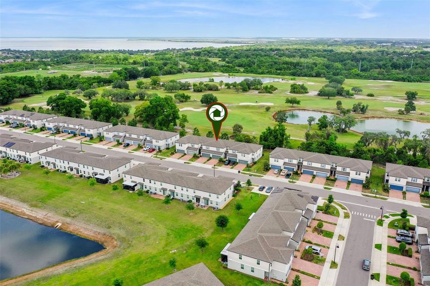 Situated at the rear of the desirable Greens at Forest Lake community, this beautifully maintained Meritage-built townhome offers serene GOLF COURSE VIEWS and modern, energy-efficient living. Built in 2021, this spacious 1,570-square-foot residence showcases an OPEN-CONCEPT FLOOR PLAN filled with natural light, TALL CEILINGS, and neutral paint tones that create a warm and inviting atmosphere. The heart of the home is the expansive kitchen, featuring a LARGE ISLAND WITH BAR SEATING, rich espresso-colored cabinetry, GRANITE COUNTERTOPS, stainless steel appliances, a pantry, and abundant storage—perfect for both everyday living and entertaining. CERAMIC TILE FLOORING flows throughout the main living areas, and a convenient half bath is located downstairs. Upstairs, you'll find a versatile LOFT space, a dedicated LAUNDRY ROOM, and three generously sized bedrooms. The primary bedroom is ensuite with a DOUBLE-SINK VANITY, a spacious walk-in closet, and a private water closet. The two additional bedrooms share a well-appointed Jack-and-Jill bathroom. Additional highlights include a 2-CAR GARAGE with epoxy floor, a paver driveway, and ample guest parking nearby. The HOA provides lawn maintenance, along with access to COMMUNITY AMENITIES such as a pool, clubhouse, playground, and dog park. Ideally located with access to the popular WEST ORANGE TRAIL at the community entrance, this home is also close to shopping, dining, medical facilities, schools, and offers easy access to major highways.