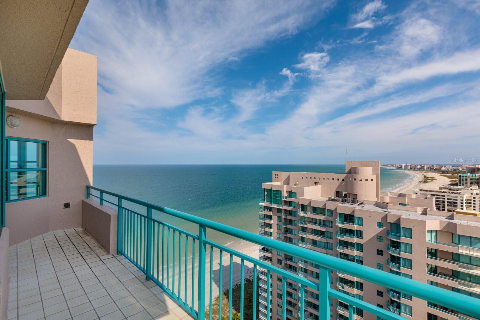 RARELY AVAILABLE 2 STORY PENTHOUSE, CORNER UNIT WITH COVETED 4 CAR PRIVATE GARAGE #14, WITHIN THE PARKING GARAGE. Located on desirable Sand Key this condo has soaring 18 ft ceilings in the living room with window wall overlooking the Gulf of Mexico. Wood burning fireplace creates beautiful ambiance for those occasional cool nights. Wrap around balconies afford 270 degree views of the Azure Gulf of Mexico and the nighttime lights of the Intracoastal. Luxurious 3 bedrooms & 3.5 baths recently updated in Chic Coastal Style by Decker Ross Interiors . Also has a den/office on the main level. European Travertine floors on the main level with wood look tile on the stairs & 2nd level. Open kitchen has black granite tops, white cabinets, cooking island & stainless steel appliances. Kitchen opens to dining area Fantastic water views from every room. See all the way north to Honeymoon Island & south to the Sunshine Skyway Bridge. Relax on any of your balconies, while having a cool drink, feeling the tropical breezes. Birds eye view of the fireworks for the holidays up & down the beach & all the way to Dunedin, Tampa, St Pete & beyond. Dual water heaters, dual A/C units. Large laundry room with laundry tub along with front loading washer & dryer. The World Class community of Ultimar on Sand Key offers true resort style living with 3 geo-thermal heated pools & spas (one is a lap pool). 3 tennis courts, pickle ball, basketball court, putting green, grill area, fire pit area, shuffleboard, corn hole, club room, median room, billiards room, social room, steam & sauna, 24hr guard gated. Walk to great restaurants & shops or catch the beach trolley right !out in front of the building. A short drive to Tampa & the airport plus all the sports venues of our championship teams. See virtual tour! Call for your private showing! Start Living the Florida Beach Lifestyle Today! Ultimar 2 has been through Milestone & SIRS Inspections. No issues. They are fully funded & their fees did not go up for 2025 despite the insurance increase.