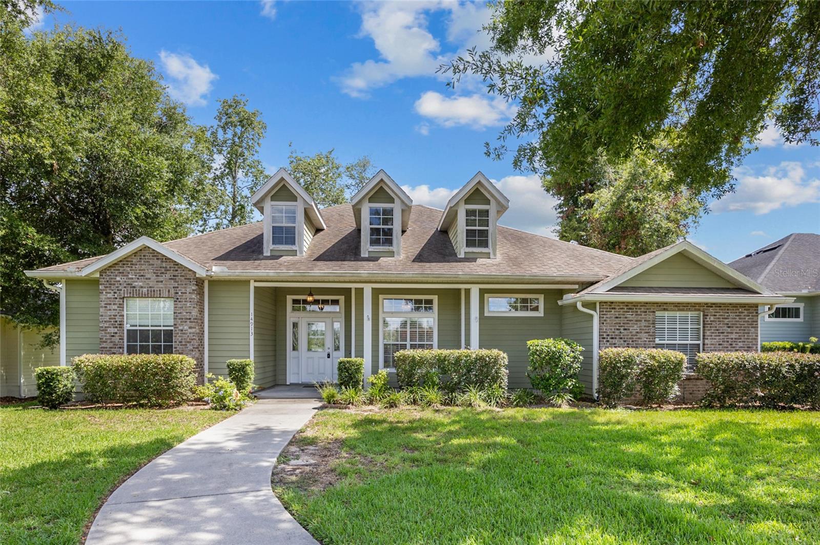 One or more photo(s) has been virtually staged. Welcome home to this turn-key 4 bedroom / 3 bathroom home located in the gated community of Wyndswept Hills in Alachua. The open floorplan is light and bright featuring a seamless transition between the great room, kitchen and dining area in this true 3-way split concept. The spacious kitchen features stainless steel appliances, granite countertops, rich-brown toned cabinets, pantry and functional peninsula providing additional seating options. Enjoy the designated eat-in kitchen area with views of lanai and great room which is enhanced with crown molding and recessed ceiling, built-in display case and wall insert fireplace. Continuing with the main living area open feel, is the separate dining space all showcased with arched doorways. Engineered hardwood flooring shines throughout the main living areas and luxury vinyl plank flooring in all bedrooms, no carpet. Stepping into the primary suite it boasts a generous space for additional sitting area with direct access to lanai and accented by recessed ceiling and crown molding. The spa-like en-suite bathroom features separate dual vanities, jetted tub, glass enclosed shower, water closet, two walk-in closets and window.
Secondary bedroom has large wall closet with en-suite bathroom featuring a large vanity, tub/shower combo and transom window. Bedroom three and four both have wall-closets and the conveniently located 3rd full bathroom has vanity, tub/shower combo and transom window. Oversized laundry room with sink and an abundance of cabinetry makes for a great butler’s pantry. 2 car garage with attic pull-down storage for all those seasonal items. Alley driveway for rear entry garage, storage shed, no fencing. Great location just minutes from I-75 and 441, grocery, shopping and entertainment.