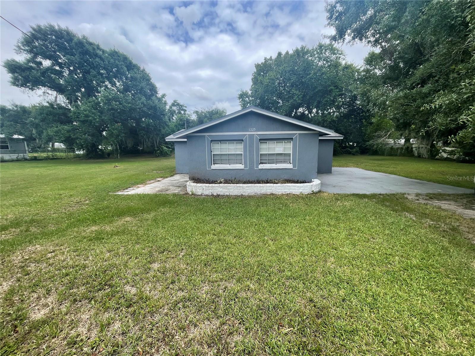 1/3-acre in Auburndale - with NO HOA or CDD! This home offers freedom with a central location. 4 bedrooms, 2 bathrooms, 1496 square feet with storage shed. Step inside to a generously sized living area with updated wood vinyl flooring and an open concept floorplan. The kitchen and dining room are within easy conversational distance to the family room. The kitchen includes updated modern white cabinets and a tile backsplash, granite counters, white appliances and views of the private backyard. Utility room in conveniently located inside, directly off the kitchen. The primary suite includes closet, updated vanity and step in shower. The secondary bedrooms share a full size bathroom. Great location, near restaurants, shopping and the interstate. It's good to be home.