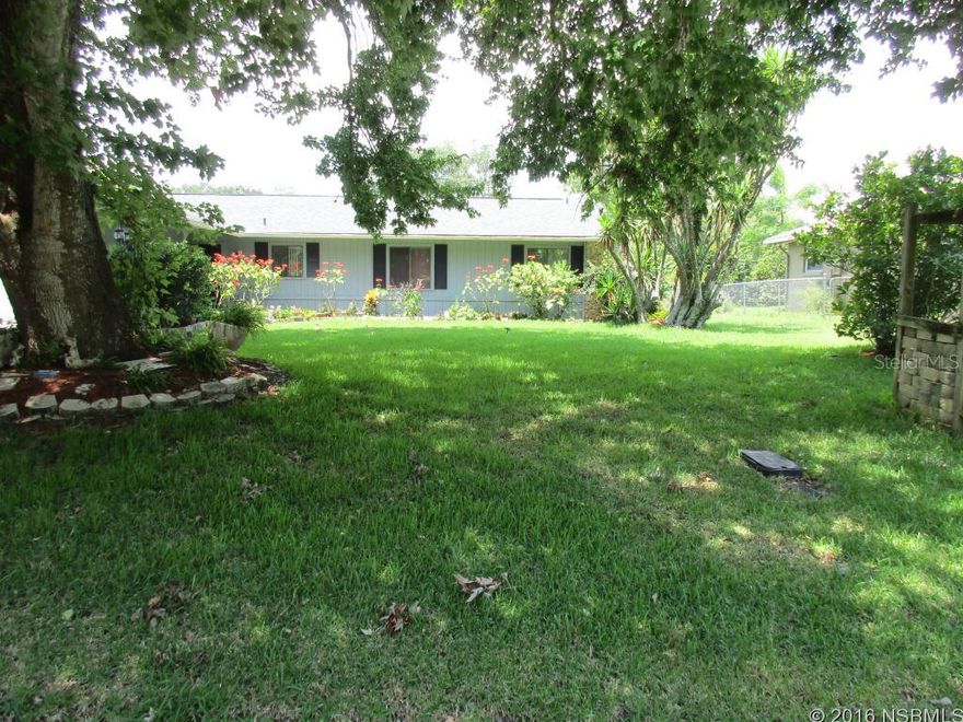 Check out the size of this living room 14x27 with sliders that open to screened porch.  Tons of room for entertaining. Decking that leads to workshop , gazebo and grill area.  Fruit trees and reclaimed water.  Kitchen has lots of cabinets. Tile throughout with custom tile work in showers.  Master bedroom has large walk in closet. Skylights in both baths. This home is waiting for new owners.  Come see and envision all those parties. Newer roof. Gutters ;Water: City