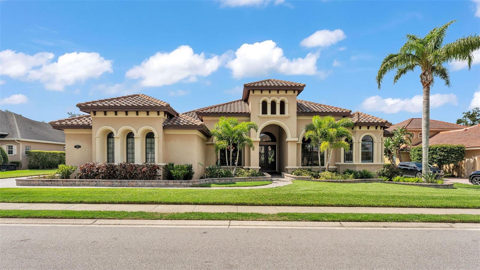 Welcome to 6572 Eagle View Loop, a stunning Mediterranean-style estate nestled in the heart of The Preserve at Eaglebrooke North, one of Lakeland’s most sought after 24-hour guarded and gated Country Club communities. This impeccably maintained 5-bedroom, 3.5-bathroom custom home spans 3,546 square feet of refined single-level living and sits on an expansive 0.34-acre lot. Built by award-winning Hulbert Homes, this residence offers the perfect blend of elegance, comfort, and modern convenience. A grand barrel tile roof, paver driveway, and elegant eight-foot double front doors set the stage for the luxury found within. Step inside to discover a freshly repainted interior (August 2025) and rich hardwood flooring added in 2023, complemented by sleek tile throughout the wet and common areas. Every detail is carefully curated from the custom closets by Closets by Design to the classic Florida Plantation Shutters gracing the windows. The gourmet kitchen is the heart of the home, featuring custom wood cabinetry, granite countertops, stainless steel appliances, and a spacious island. A built-in double oven, gas cooktop with decorative hood, and microwave make culinary endeavors a delight, while the breakfast bar comfortably seats four. The adjacent wet bar with a built-in icemaker is perfect for entertaining guests. The living room is anchored by a stunning stone-accented gas fireplace, offering a warm and inviting space to gather. This home also includes a private study and a versatile bonus/theatre room, designed to fit your lifestyle needs. The primary suite is a true retreat, showcasing a spacious bedroom with custom closets and an opulent en-suite bathroom featuring granite counters, abundant cabinetry, a walk-in shower, and eye-catching decorative mirrors. Step into your outdoor paradise with an expansive screen-enclosed lanai with paver flooring, recently refreshed in 2024 with new screening, tie-downs, and three new outdoor fans in 2025. Enjoy Florida’s year-round sunshine by the beach entry pool, a resort-style feature with a gradual, walk-in slope that mimics the shoreline of a tropical beach. This luxurious pool is enhanced with a sun shelf, soothing fountains, and two built-in seating areas for ultimate relaxation. A tranquil waterfall completes this private backyard oasis. Notable upgrades include a full-home Generac 26kW generator (2024), water softener and reverse osmosis system (2023), and a Bosch 800 dishwasher (2023). The pool pump, salt system, and valves were also updated in 2023, ensuring peak performance. Two brand-new AC systems were installed in August 2025 for optimal climate control year-round. Additional features include a beautifully landscaped Zoysia lawn with upgraded outdoor lighting (2024), and a new ice machine added in 2025 for everyday convenience. The oversized three-car garage offers plenty of space for vehicles and storage, while the meticulously serviced irrigation system keeps the grounds lush and vibrant. Residents of Eaglebrooke enjoy access to a 4½-Star Championship Golf Course, Junior Olympic swimming pool, tennis, pickleball courts, and a clubhouse with formal dining, sports bar, event space, and a fully stocked pro shop, all with available membership options. Luxury, comfort, and resort-style living await you at 6572 Eagle View Loop where every detail has been thoughtfully crafted for the most discerning homeowner.