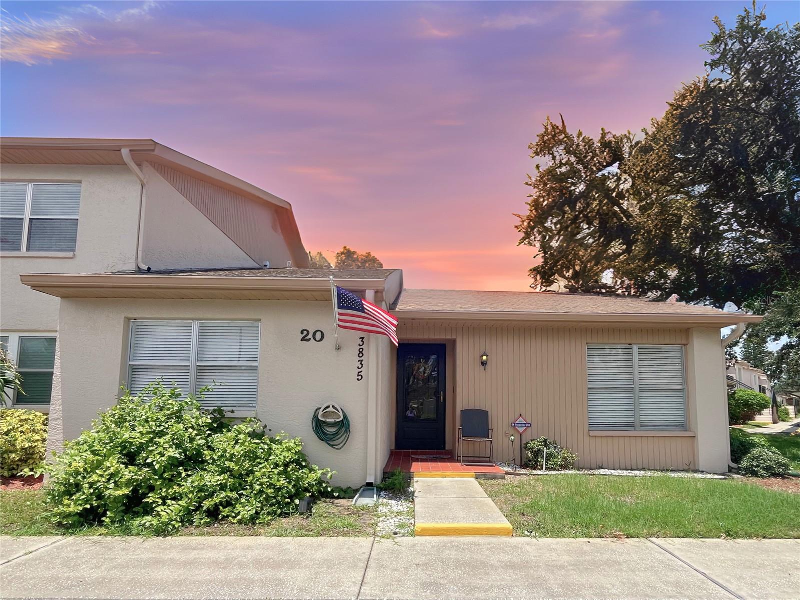 If you want serene water views and generous square footage without the maintenance, this home is for you! This SPACIOUS 2 BEDROOM 2 BATH, CORNER UNIT is located minutes from the Gulf and historic downtown Tarpon. Tour the sponge docks for some amazing food and shopping or head over to Fred Howard for some beach time. When it’s time to relax, your new home offers a peaceful retreat. From the moment you enter, you’ll enjoy a spacious open living room and dining room area. This END UNIT features an abundance of windows and sliding door, letting in that beautiful Florida sunshine. Watch wildlife play in your backyard with stunning pond views while you enjoy your morning coffee from your covered lanai. Light flooring and vaulted ceilings throughout the main living space adds to the open feel. The kitchen opens up to the dining area and provides bar seating so you can interact with guests and enjoy an open vibe as you prepare meals. The chef in the house will love the large kitchen with plenty of cooking space and an updated backsplash. The split floor plan provides privacy and comfort, with a spacious primary suite featuring a huge walk-in closet, dual vanities, a walk-in shower, and a separate vanity area. The guest bedroom is located on the opposite side of the home, adjacent to a full bath with a relaxing tub and large vanity. A dedicated indoor laundry room and abundant storage make everyday living effortless. This low maintenance home features Newer A/C and nearly everything paid for in your low monthly dues. The association fee covers cable, wifi, trash, utilities, pest control and maintenance of the common areas such as the roof, etc. This active 55+ community hosts social events at the clubhouse, shuffle board and has a gorgeous pool to cool off on those hot summer days! NO FLOOD ZONE offers additional piece of mind. Washer and Dryer is included and the condo can come FULLY FURNISHED. This home is priced to move and offers everything you need to make your Florida dream come true!
