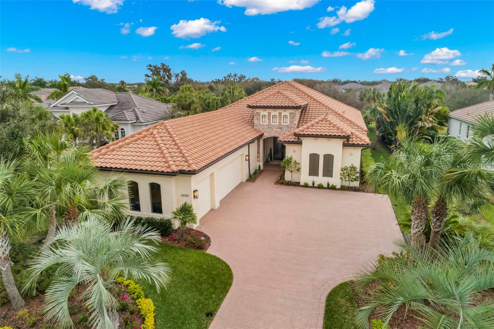 Experience opulence in this Executive UPDATED London Bay inspired custom home nestled within the highly sought-after GOLF COMMUNITY-Founders Club, A private 18-hole Robert Trent Jones championship course with an amazing clubhouse and restaurant/bar on site. The lavish interior of 3507 Founders Club Drive boast soaring ceilings, an abundance of windows, custom architectural features at every turn, walls of 10FT sliding doors blending indoor/outdoor living with the expansive outdoor entertaining area complete with outdoor kitchen, all overlooking the sparkling oversized salt water pool/spa and a picturesque backdrop of the preserve The kitchen/family room combination features volume ceilings and an abundance of sliding doors and windows showcasing the tropical landscaping, it is truly a bright happy feel. One will enjoy natural gas cooking, rich custom cabinetry enhanced with quartz, butler’s pantry with wine cooler, large pantry closet, professional grade appliances, reverse osmosis filtration at sink, oversized waterfall island for casual dining, this fabulous oversized area is truly the heartbeat of the home. ALL BEDROOMS ARE EN-SUITES with custom walk in closets in addition to being strategically placed for privacy and functionality. The primary suite features 2 customized walk in closets, A spa like bath of fresh contemporary finishes, a soaking tub and custom walk in shower. If one must work occasionally or need an additional room, you will find privacy in the dedicated den/office located in the front of the home. Founders Club is a lifestyle like no other, vibrant and enriching with golf and social memberships available to residents, offering wellness programs inclusive of tennis, fitness, Pilates and massage therapy, Golf and a 24,000 sq ft Golf hall offering fine dining, bar and grille. The community is ideally located mins from I-75 offering an easy commute to DOWNTOWN SARASOTA, THE AIRPORT, UTC MALL, GULF BEACHES, LAKEWOOD RANCH and all the places you wish to be to enjoy dining, arts of downtown Sarasota, and the Florida lifestyle! ! Founders Club is recognized for its incredible balance of nature preservation and well planned custom architectural homes. Come live the lifestyle!