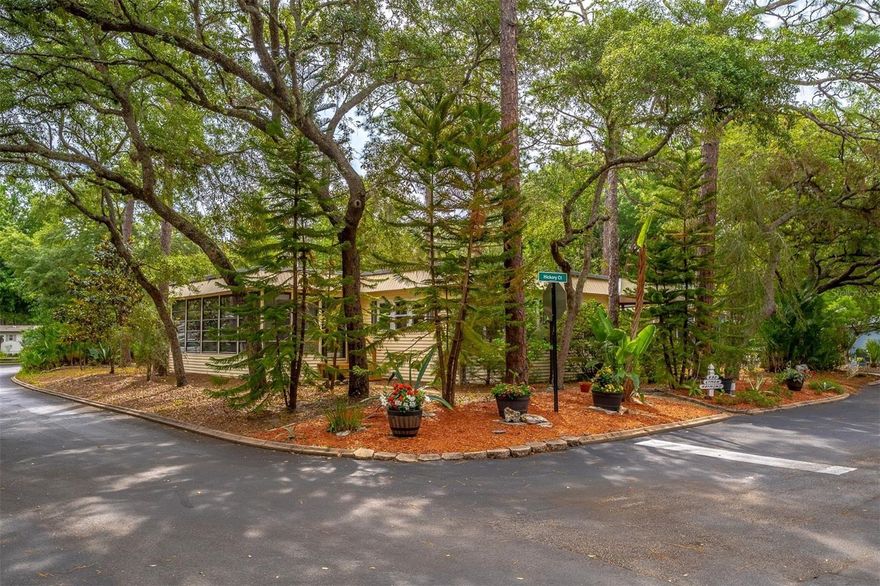 Located in the highly sought-after 55+ community The Forest in the heart of Lake Mary.  This absolutely beautiful and meticulously maintained 2-bedroom, 2-bath home sits on a spacious corner lot on a quiet cul-de-sac directly across from the clubhouse with magnificent views of the community’s natural park-like setting. One of the rare features of this property is the additional outdoor space perfect for planting your own garden and enjoying the Florida lifestyle. From the moment you walk inside, you’ll appreciate the bright open floor plan, spacious rooms, and numerous upgrades throughout. The large kitchen offers an abundance of counter space, beautiful cabinetry with glass upper doors, stainless steel appliances, wainscoting details, and a warm inviting feel that flows seamlessly into the dining area and oversized living room. All windows throughout the home have been updated, allowing for abundant natural light. Just off the living room is an expansive Florida room surrounded by windows on three sides, creating the perfect space to relax or entertain. The Florida room also has direct access from the guest bedroom. The guest and primary bedrooms are connected by a shared office/flex space, ideal for hobbies, reading, or working from home. Additional interior features include an indoor laundry closet, walk-in pantry, immaculate storage room with built-in shelving, and exceptional storage throughout the home.  The spacious primary suite is bright and welcoming with a walk-in closet and an updated ensuite bathroom featuring a beautiful walk-in shower. Just outside the primary bedroom is a cozy private patio overlooking the backyard, perfect for enjoying morning coffee or relaxing evenings.  The Forest is one of Seminole County’s most desirable resident-owned communities where you own your land — a rare find in this area. The community features a stunning clubhouse with a Frank Lloyd Wright architectural feel and an incredibly active social lifestyle with monthly dances, events, clubs, and activities. Residents enjoy two swimming pools including one heated year-round, men’s and women’s saunas and locker rooms, tennis courts with pickleball lines, shuffleboard courts, bocce ball, water volleyball, Mahjong, cards, dominoes, and so much more. There is also a separate community building featuring a large gathering room, billiard room, poker room, library, craft room, and coin-operated laundry facility. RV and boat parking is available on a first-come, first-served basis for a nominal one-time fee. The low HOA includes cable, internet, and trash service. The location is unbeatable — you can walk right outside the community to major shopping, grocery stores, restaurants, and the Seminole Wekiva Trail, while still being just minutes from I-4 and everything Central Florida has to offer. Don’t wait — this exceptional home will not last long!