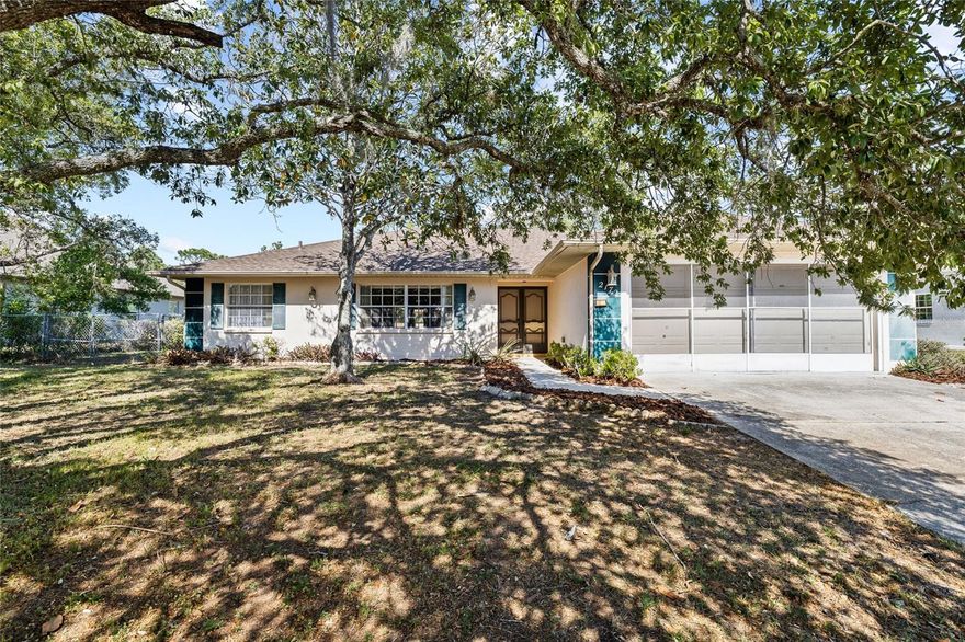 One or more photo(s) has been virtually staged. Located on OVER 1/2 ACRE ... No HOA dues!  This 2 bedroom, 2 bath with popular split floor plan features a NEW Roof (2025) (dimensional shingle) and gutters!  There is laminate flooring throughout the majority of the house, NEW carpet in the living and dining rooms.  The kitchen opens to the family room and features granite countertops with an undermount sink, NEW disposal, & all kitchen appliances are included.  Adjacent to kitchen is an informal dining area.  There is a spacious secondary bedroom and the hall bath also features granite counters with undermount sink.  The primary bedroom has a walk-in closet and walk-in shower.  The indoor utility room has a storage cabinet and the washer and dryer are included.  The Florida Room has windows and tiled floors.  Two-car garage has a pull-down attic stairs and a screen door. There is an open patio and a pergola. Backyard is fenced and there is a storage shed.  This property has great access to the Suncoast Expressway making it an easy commute to the Tampa area.