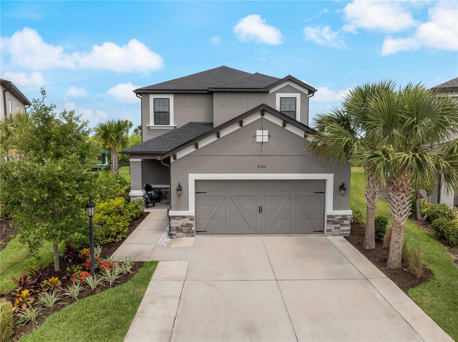 Just half a mile from the vibrant Hub and with the brand-new K-8 Sky Ranch School right across the street, your Sarasota dream starts here with TWO PRIMARY SUITES, a HEATED POOL, and NATURE VIEWS in Skye Ranch. This stunning 4-bedroom, 3.5-bath home with TWO FULL PRIMARY SUITES (one upstairs, one down!) is the perfect setup for MULTI-GENERATIONAL LIVING or LONG-TERM FLEXIBILITY, and it’s tucked on a serene CORNER LOT BACKING TO A PRIVATE NATURE PRESERVE in Sarasota’s beloved lifestyle community, SKYE RANCH. Move-in ready with FRESH PAINT INSIDE AND OUT, BRAND-NEW CARPET, and an extended layout that includes a THEATER ROOM, SPACIOUS LOFT, and open-concept living spaces built for CONNECTION and COMFORT. Step outside and feel like you’re on vacation every day with a HEATED POOL, NEW TROPICAL LANDSCAPING, and no rear neighbors—just peace, privacy, and preserve views. Worried about Florida weather? Skye Ranch isn’t just a place to live—it’s a place to THRIVE. Families here gather for FOOD TRUCK NIGHTS, outdoor movies, and zip around on golf carts to THE HUB, a 25,000-square-foot RESIDENT AMENITY CAMPUS with a RESORT POOL, OLYMPIC LAP POOL, INDOOR COURTS, ROCK CLIMBING WALL, CAFÉ, KIDZ ZONE, and so much more. The brand-new Sky Ranch School ACROSS THE STREET is already open, serving grades K-6 in 2025, K-7 in 2026, and K-8 in 2027.