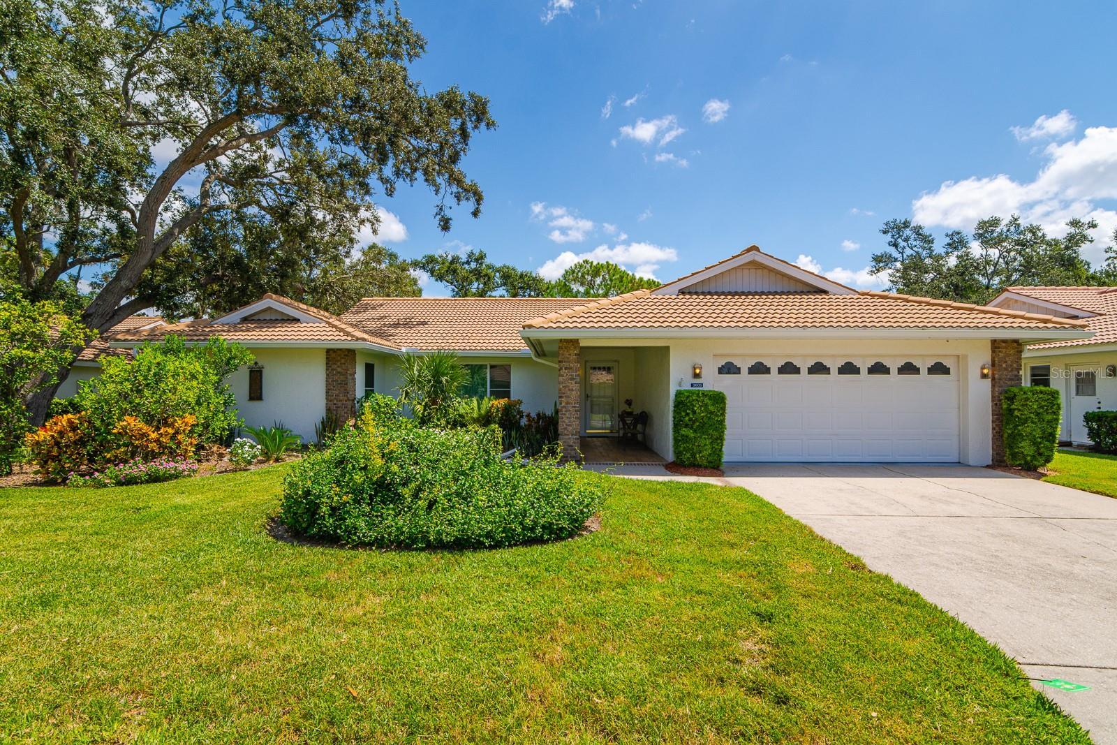 Welcome to Garden Lakes Village, a highly sought-after active adult community in East Bradenton, just minutes from State Road 70 and all the conveniences of daily living. Nestled in a tranquil, park-like setting shaded by mature landscaping and majestic oak trees, this 3-bedroom + den, 2-bathroom villa offers the perfect blend of comfort, convenience, and Florida charm.
With nearly 1,900 square feet of living space, this maintenance-free home boasts excellent curb appeal, bright open living areas with high ceilings, and new hurricane-impact windows throughout for added peace of mind. The 2022 A/C ensures efficient cooling year-round, and the spacious 2-car garage offers ample storage.
Enjoy an eat-in kitchen with stainless steel appliances, a separate inside laundry space, and a large pavered lanai—ideal for entertaining or relaxing in your private outdoor oasis. You'll also appreciate the generous storage throughout, making it easy to keep everything organized.
Garden Lakes Village offers a resort-style lifestyle with access to a clubhouse featuring a fitness room, library, billiards, card room, and kitchen, as well as a heated pool, pickleball, tennis, and shuffleboard courts, plus scenic walking paths and peaceful lakeside decks. Residents enjoy a vibrant calendar of activities including clubs, games, yoga, water aerobics, potlucks, and more.
The low HOA fee covers lawn care, exterior maintenance, irrigation, basic cable, internet, trash, pest control, and common area upkeep—so you can enjoy your time without the hassle.
Located close to Publix, ALDI, Walmart Neighborhood Market, and local dining favorites like First Watch, Poblano’s, and Peaches, you’re also just a short drive from golf courses, parks, medical centers, and the stunning beaches of Anna Maria Island and Longboat Key. Explore nearby downtown Bradenton, known for its Riverwalk, cultural events, and coastal charm.