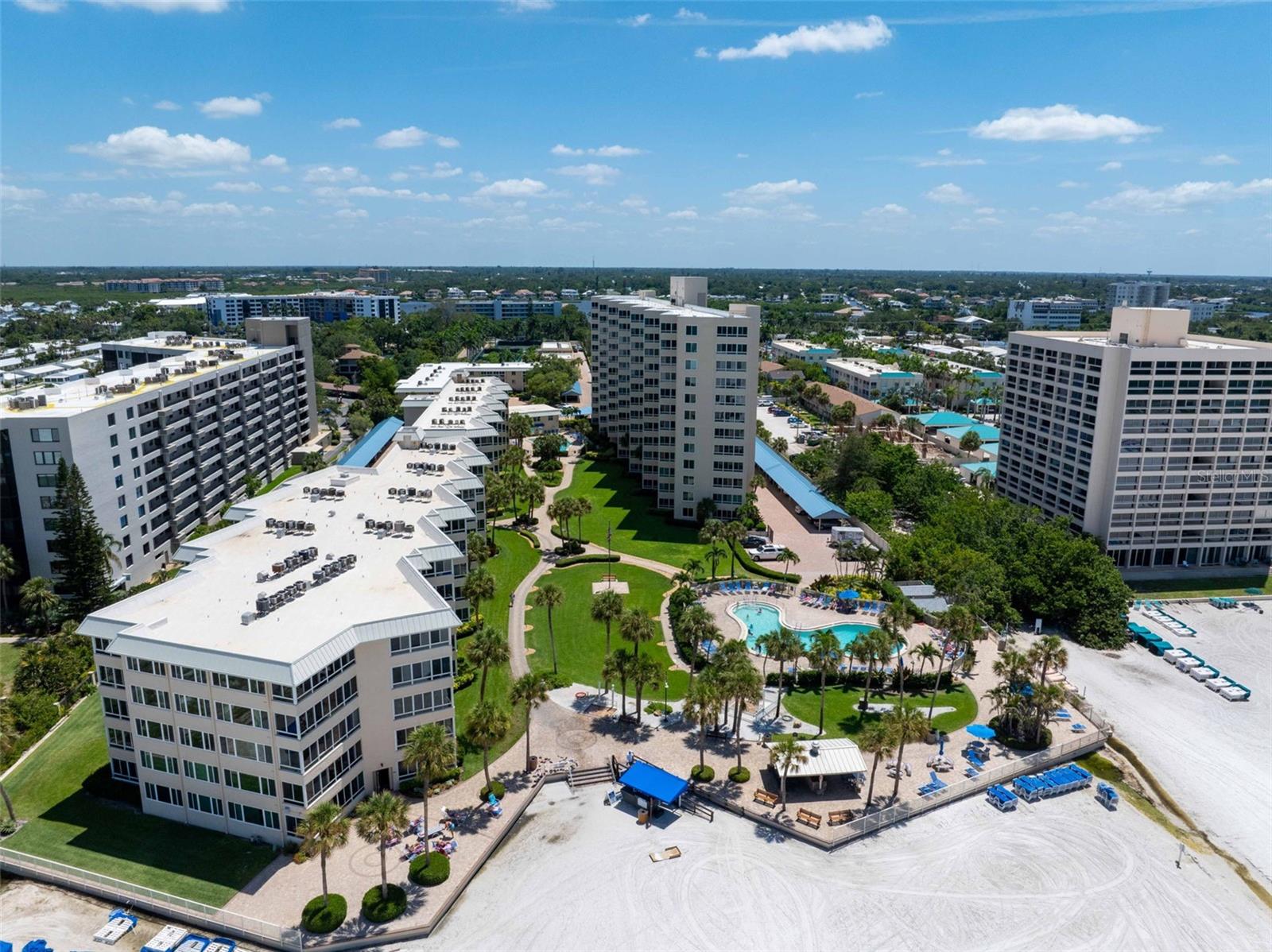 Drop everything! This is the one you have been waiting for. Imagine sitting at your coastal bistro set in the lanai of your ground floor condo in the W building of Siesta Key’s premier beach front resort, Sarasota Surf & Racquet Club. With the windows open, the scent of your morning coffee mixes with the saltwater breeze while the view is dotted with palm trees lining the path to the sparkling Gulf of Mexico waters. This open concept space is the definition of move in ready with handsome driftwood inspired floors throughout and comfortable, casual furnishings accented by whimsical décor. The kitchen is bright and white with updated recessed lighting, stainless appliances and glass cabinetry to display your special table or glassware. The luxurious principal suite is an owner’s dream with plush furnishings, crown molding and plantation shutters, but the showstopper is the en-suite bath. Pamper yourself in this fully renovated space with impeccable attention to detail including the enormous shower with dual shower heads and frameless glass shower doors. The guest space is generous with two additional beds, loads of closet space and an additional, well-appointed and renovated bath. Want more? This condo offers in unit laundry, very uncommon and so convenient for your sandy Siesta lifestyle! Sarasota Surf & Racquet offers the best of the Florida lifestyle on 13 acres of beachfront property with amenities that include two large, heated swimming pools; three tennis courts and two pickleball courts; a well-equipped fitness center; beachside and poolside barbecue grills. A top notch onsite rental service is available for your convenience. This property checks every single box for the owner or owner/investor, don’t delay as this property won’t last!