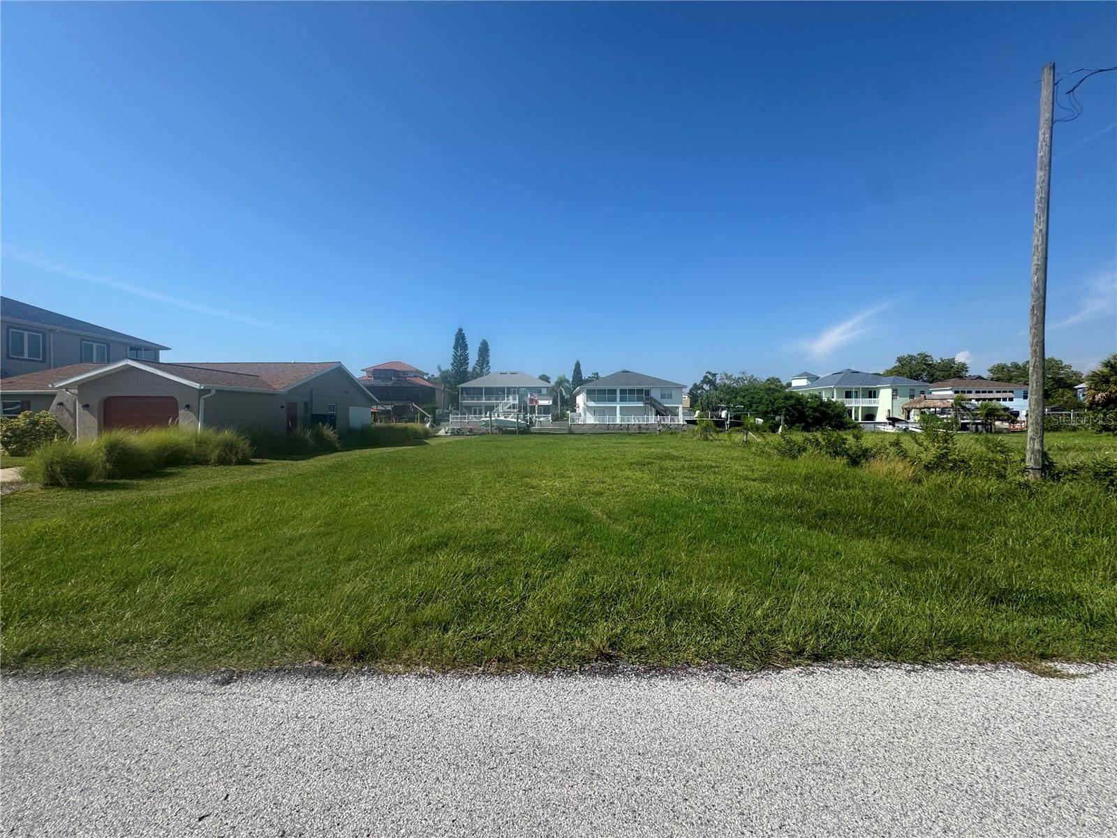 Build your dream waterfront haven on this prime cleared 6,000 sq ft parcel at 7429 Hatteras Drive in Hudson, FL. Featuring 60 feet of canal frontage, the lot includes an updated seawall and sidewalk, ensuring ease of access and peace of mind. The canal leads directly to the Gulf of America, offering world-class fishing, boating, and stunning sunsets from your future backyard.
Located in the desirable Sea Pines community, this property offers more than just land — it’s a lifestyle. Sea Pines is a waterfront neighborhood known for its natural beauty, community pride, and unbeatable access to the Gulf. Residents enjoy a laid-back coastal atmosphere with nearby waterfront dining, Hudson Beach, and easy cruising distance to popular boating destinations like Anclote and nearby barrier islands. Whether you’re into island-hopping, fishing excursions, or sunset sailing, this is the perfect launching point.
With the lot already cleared and utilities nearby, you’ll be well on your way to building your custom coastal retreat. Just one hour from Tampa International Airport and two hours from Orlando, Hudson strikes the perfect balance of laid-back charm and modern convenience. Don’t miss this rare opportunity to own cleared waterfront land in one of the Gulf Coast’s best-kept secrets!