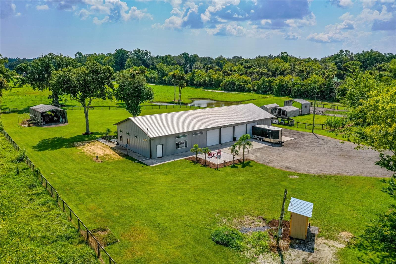 Beautiful 8.26 acres of fenced agriculture prime property WITH a 40x100 enclosed pole barn. The pole barn has a nicely decorated finished air-conditioned space with stained and polished concrete floor, drywall, bathroom with shower, utility room with washer/dryer hookups, storage areas and ample air-conditioned space for comfort, relaxation, and recharge. Enclosed barn also has large garage/storage area with 4 large overhead doors each with electric opener making it convenient to move and store recreational toys and equipment along with secure storage out of the weather. Pole barn is serviced with 200-amps power along with a water softener. The property is cleared fenced and cross fenced with green pastures providing opportunity for large garden and/or raising of livestock and possible consideration of agriculture tax exemption. There are additional sheds and agriculture/storage purpose buildings on the property as well. Has a separate 50-amp RV connection. Property is approx. 200’ off paved road with secure keypad gated entrance providing for additional privacy. Plenty of additional cleared property allowing for additional structures/home(s) and located in a peaceful area while still very convenient to businesses located in the City of Oak Hill.