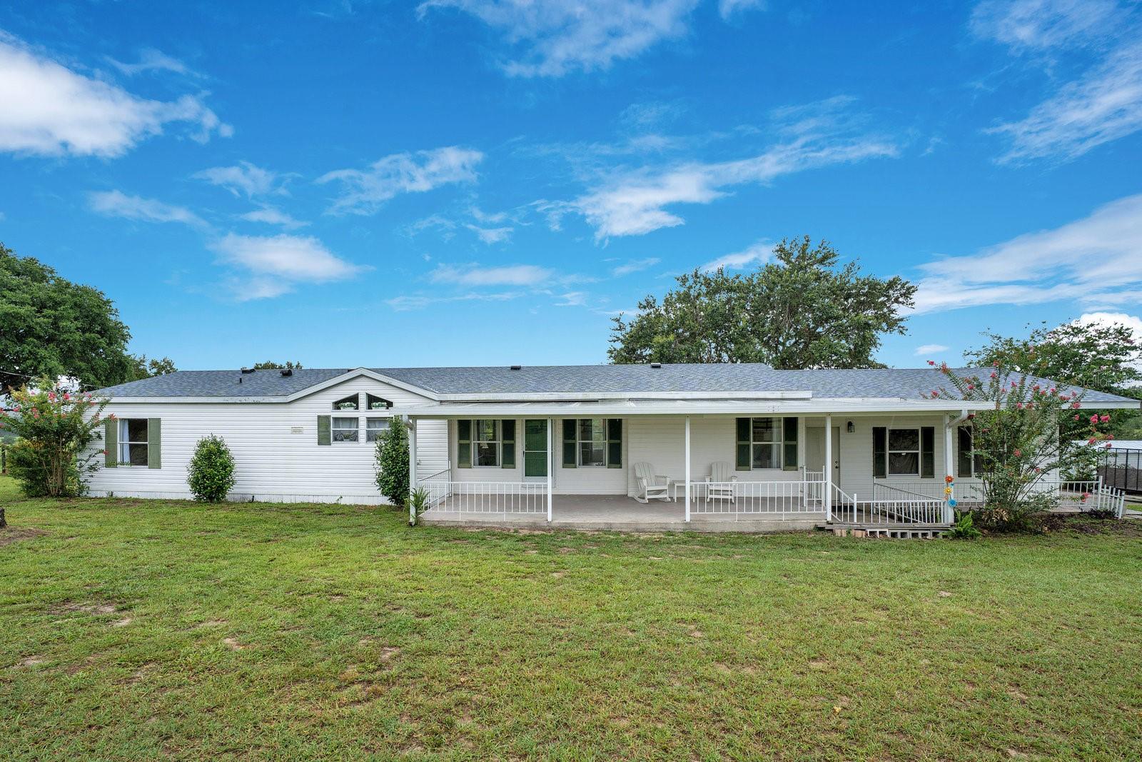 Under contract-accepting backup offers. Welcome to your private slice of country paradise! Nestled on a spacious 2.96 -acre lot, this beautifully remodeled and fully furnished 3-bedroom, 2-bathroom mobile home offers the perfect mix of modern updates and country charm. Whether you're looking for a starter home, a place to downsize with land, or a peaceful rural retreat, this property is move-in ready and full of potential. Step inside and you’ll immediately notice the fresh, airy feel. The open-concept living and dining area features new flooring, updated light fixtures, and a neutral color palette that complements any style. The kitchen has been completely refreshed with ample cabinetry, and stainless steel appliances—ideal for both everyday living and entertaining. The split-bedroom layout offers privacy and flexibility. The primary suite is spacious and inviting, with a walk-in closet and a fully renovated en-suite bath featuring a new vanity, modern fixtures, and an updated shower. Two additional bedrooms and a second full bathroom provide space for family, guests, or a home office. One of the standout features of this home is the large screened-in back porch—the perfect place to enjoy your morning coffee, read a book in the afternoon breeze, or unwind after a long day while overlooking your beautiful backyard. It’s an ideal spot for outdoor dining, entertaining, or simply soaking in the peaceful views of the surrounding countryside. The 2.5-acre lot offers endless possibilities. Whether you’re dreaming of starting a garden, raising animals, building a workshop, or just enjoying the extra space and privacy, this property gives you the freedom to do it all. With no HOA, you’ll have the flexibility to truly make it your own. Homes with this kind of space, style, and value don’t come around often. Don’t miss your chance to own a move-in ready home with land—schedule your private tour today! Located less than one mile from Lake Weir and just minutes from the Villages. **This listing can be purchased individually or as a package with MLS #O6324663, address 14620 SE Sunset Harbor Rd**