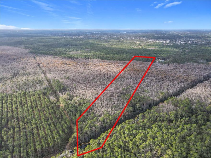 Nearly 20 acres in Deltona present a rare opportunity for both dreamers and investors. This expansive parcel is a true blank canvas, offering the freedom to design a country-modern retreat, a contemporary estate, or a multi-use development that maximizes its scale. The land’s generous size allows for endless layout options, from a single residence with room for gardens, animals, and recreation, to a thoughtfully planned subdivision or compound.  

Electric service runs along the property line, reducing infrastructure hurdles and making future development more accessible. The acreage’s natural beauty provides a peaceful backdrop, while proximity to established neighborhoods, commuter corridors, and local amenities ensures convenience without sacrificing privacy.  

For buyers, the property offers the chance to create a lifestyle that is uniquely theirs—whether it’s a wraparound porch overlooking wide-open spaces or a modern home tucked among the trees. For investors, the parcel’s location and utility access make it a strategic addition to any portfolio, with potential for subdivision, phased development, or long-term land banking.  

Large tracts with utility access are increasingly scarce in Central Florida, and this property combines scale, location, and versatility in a way that is hard to find. Whether held for appreciation or transformed into a personal estate, it offers a foundation for vision, growth, and lasting value.