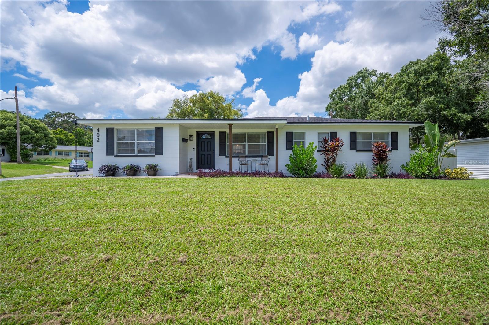 Welcome to this beautifully maintained 2-bedroom, 1.5-bath home located in the heart of Central Lakeland! This home features a spacious and updated kitchen, featuring stainless steel appliances, stone counters, and ample cabinet storage—perfect for home chefs and entertainers alike. Just off the kitchen, you'll find a convenient laundry room complete with a versatile pantry/dry bar area. This home features a flexible bonus room that can easily serve as a home office, library, formal dining room, or creative space to suit your lifestyle. Both bedrooms are generously sized, with the primary bedroom offering a private en suite half-bath for added comfort. Enjoy peace of mind with major updates already taken care of, including a new roof and A/C in 2023. Venture outside to your fully fenced backyard oasis, featuring low-maintenance turf, brand new 2024 vinyl fencing, and fresh 2024 landscaping —ideal for pets, play, or relaxing weekends. Don’t miss the chance to own this move-in ready gem in a prime location close to everything Lakeland has to offer!