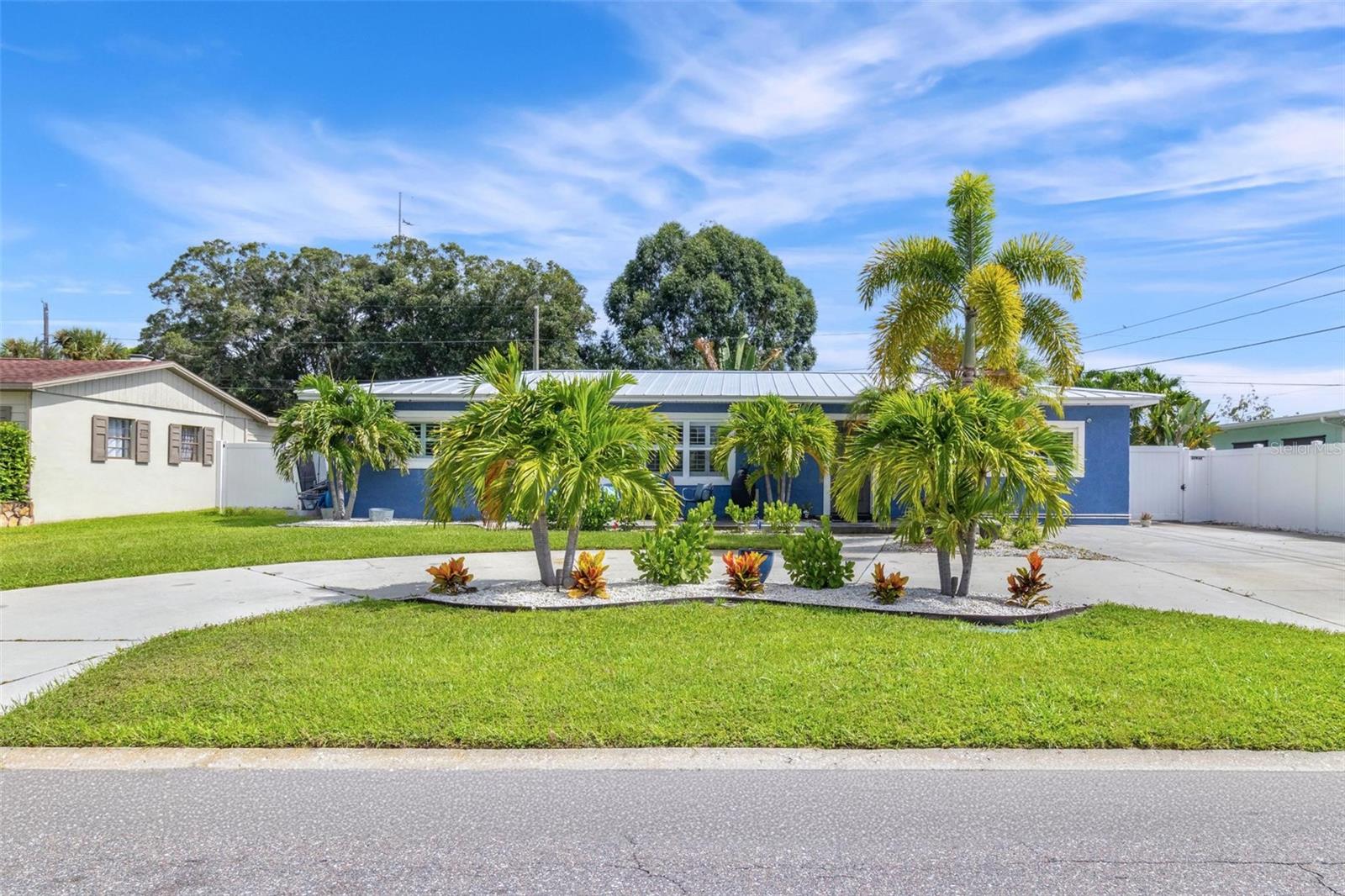 Introducing this charming 3-bedroom, 2-bathroom home in the sunny city of St. Pete, where you'll find a blend of modern updates and convenient features. Situated in a prime location, this home offers easy access to nearby amenities while providing a tranquil and comfortable living environment. Upon entering, you'll be greeted by an open floor plan that creates a spacious and airy feel. The heart of the home is the expansive, updated kitchen. Featuring a massive island with leathered marble countertops and tall white cabinets that extend all the way to the ceiling, this kitchen is both stylish and functional. It provides ample space for cooking and entertaining, making it a delight for any home chef. Both bathrooms in the home have been thoughtfully updated. The guest bathroom includes a tub, while the primary bathroom features a shower and direct access to the pool area. These modern and well-appointed bathrooms add a touch of luxury to everyday living. Throughout the entire home, you'll find a mix of tile and luxury vinyl flooring, which not only adds style but also offers durability and easy maintenance. The split floor plan provides privacy for the primary bedroom, ensuring a peaceful retreat. Additionally, there is a bonus room with sliders that open to a covered patio, offering additional living space that can be utilized for various purposes. Step outside into the backyard oasis, where a massive 16 x 28 saltwater pool takes center stage. Whether you're looking to relax or entertain, this pool provides the perfect setting. The backyard is fully paved with pavers, eliminating the need for lawn maintenance and providing a clean and low-maintenance outdoor space. A dog run is also included, catering to pet owners. Parking is made easy with two gates on either side of the home, providing space for parking a golf cart or small boat. The front yard is equipped with an irrigation system, ensuring a lush and well-maintained appearance. Meanwhile, the backyard requires no grass maintenance, allowing for more time to enjoy the outdoor amenities. The location of this home is another standout feature. Situated near small lakes, JW Cate Park, shopping centers, restaurants, and Tyrone Mall, you'll have convenient access to a variety of amenities. Additionally, the beaches, downtown St. Pete, and Tampa are all within close proximity, offering endless leisure and entertainment options. In summary, this home is perfect for those who appreciate modern updates, outdoor living, and convenient access to amenities. With its open floor plan, updated kitchen, saltwater pool, and prime location, this charming property provides a comfortable and enjoyable living experience.