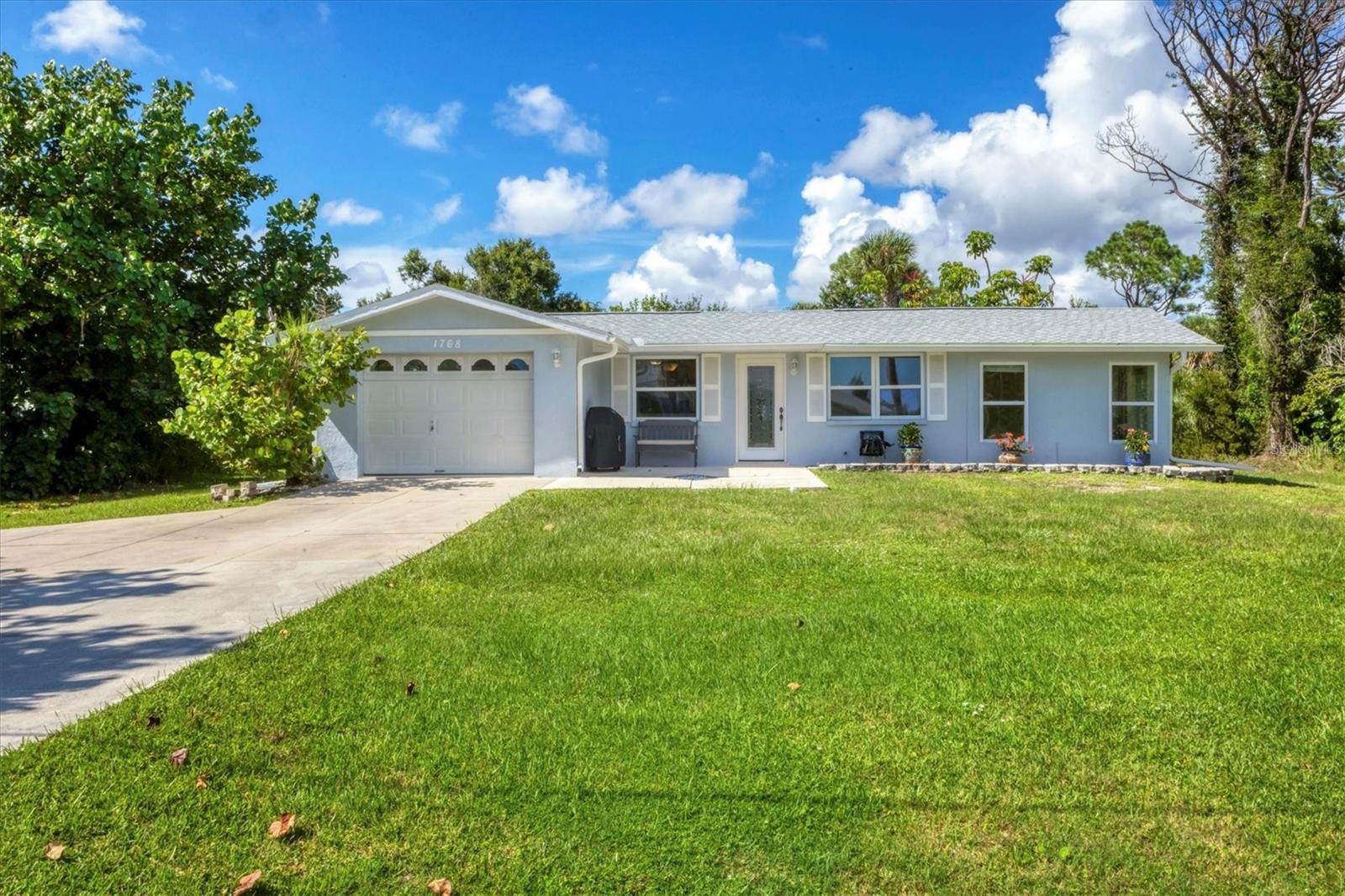 Your beach escape awaits! This move-in ready two bedroom, two bathroom home with bonus room is less than 1 mile from Manasota Beach! Located on an oversized .60 acre lot in the sought after neighborhood of Manasota Gardens. New roof (2022), new screen enclosed lanai (2024), newer air duct system, newer windows, fresh interior and exterior paint, fenced dog run, shed, and peace of mind in this solid block home that has withstood recent storms with zero damage! Tropical palms, seagrapes, and a fruiting mango tree welcome you to this private lot surrounded by mature landscape. From the front patio, the charming shutters and decorative glass door greet you. Upon stepping inside, you are in the living room with views of the kitchen and dining area to the left. Stainless appliances, large breakfast bar with storage and laminate flooring are featured. To the right of the living room, step down into the relaxing Florida room. The walls adorn with windows bringing the natural Florida landscape in. This bonus room has potential to be a third bedroom, hobby room, or office. Walk beyond the living room down the main hallway to the two bedrooms. The primary bedroom features double doors, view of expansive backyard, walk-in closet, french doors to the new lanai, and updated en-suite bathroom with granite vanity, linen closet, walk-in shower and tile backsplash. The second bedroom is adjacent to the primary bedroom, with a full bathroom down the hall. Next to the updated kitchen is the laundry room and main access to the brand new oversized screened lanai. Enjoy mornings immersed in nature, listening to the birds and evenings relaxing with a beverage or entertaining loved ones. This home has everything you need and it's in the perfect location to take advantage of southwest Florida living. Public beaches and boat ramp is just over the bridge. Manasota Key has delicious restaurants, unique shops, and tons of outdoor adventure. Between Englewood and nearby Venice, convenience and amenities are a short drive away. Golf courses, nature preserves, and fishing destinations are at your fingertips. Don't let this one get away!!