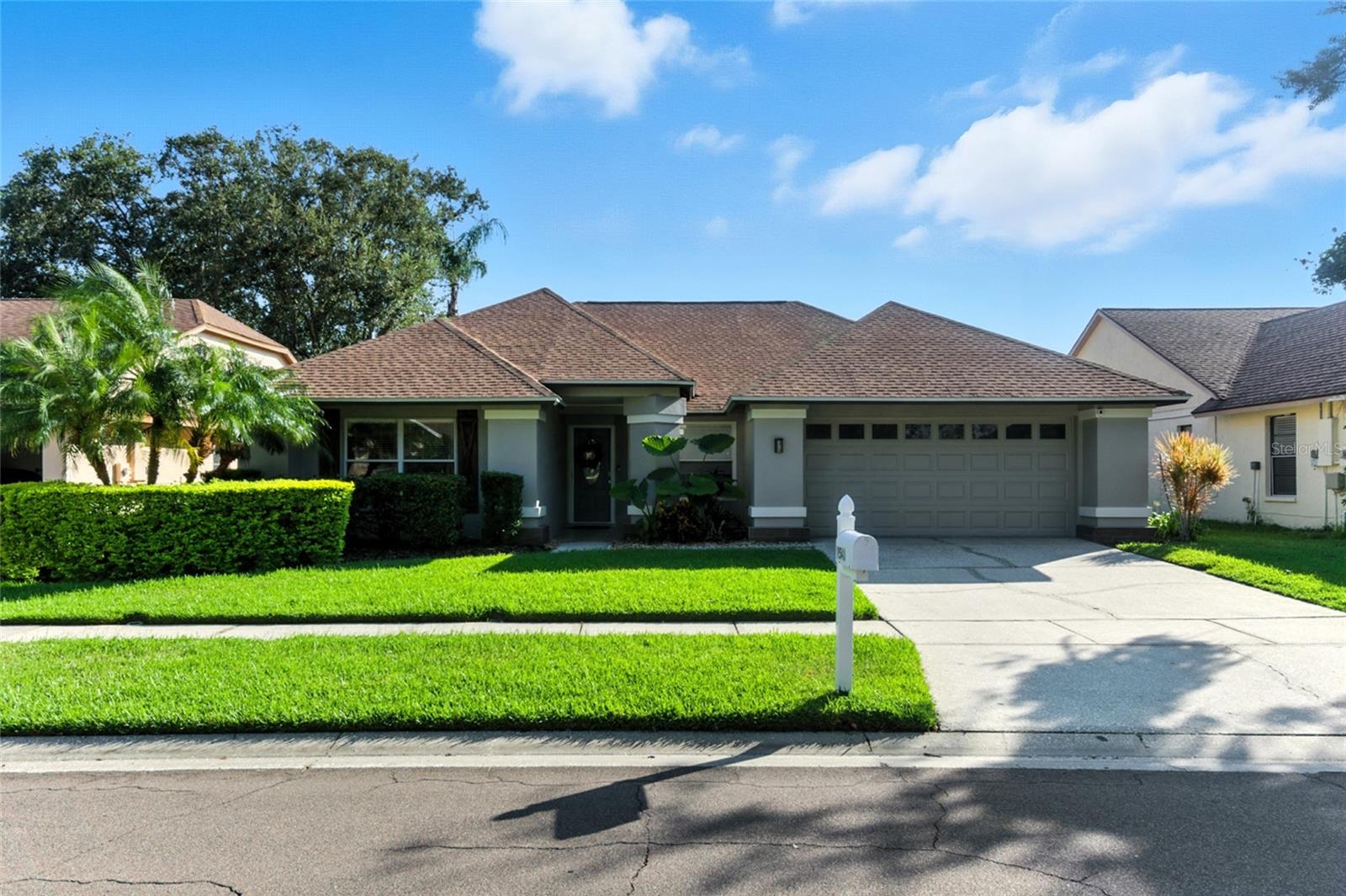 Beautifully Updated Pool Home with Serene Pond Views in Pebble Creek. Step into this meticulously maintained 4-bedroom, 2-bathroom residence featuring a spacious 2-car garage and a sparkling refinished pool—all nestled on a quiet street with a pond view and no rear neighbors. Open-concept layout with high ceilings & a wood burning fireplace in the living room. Gourmet kitchen with granite countertops, maple cabinetry, center island, and a cozy eat-in breakfast nook. Primary bath with a glass block walk-in shower, massaging jets, and modern vanities. No carpet: Porcelain tile in main living areas, hardwood in the primary & one of the bedrooms & luxury vinyl plank in the other 2 bedrooms. Peaceful pond views from the pool that offers a tranquil natural backdrop. Updates: 2025-Pool Pump; 2024-Roof, Water Heater & Dishwasher; 2021-Electric Panel, Garage Door, Pool: Resurfaced, Tile & Screening, Range/Oven; 2020-AC. Pebble Creek has no CDD and a super low HOA fee of $650 per year. Community amenities: pool, tennis courts, pickleball courts, basketball court & playground. Easy access & just minutes to I-75, I-275, Wiregrass, premium outlets, restaurants & medical facilities. Close proximity to the University of South Florida, VA Hospital, Moffitt Cancer Center and downtown Tampa with all it has to offer.