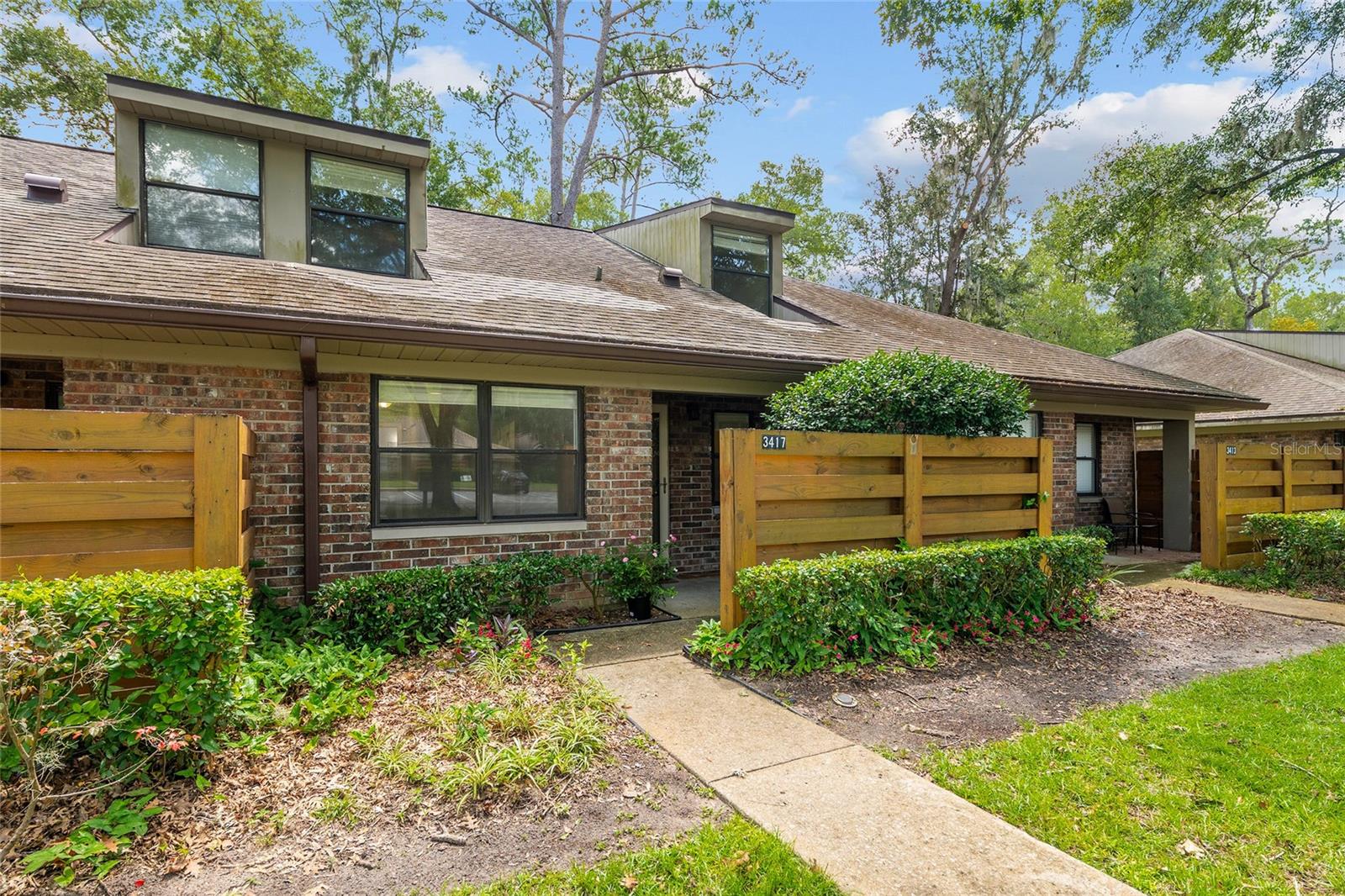 Welcome to Timberway – A Hidden Gem! Fall in love with this rare 3-bedroom, 2-bathroom townhome featuring a sunporch and private stone patio — perfect for morning coffee, birdwatching, or weekend grilling! With 1,364 square feet, this is one of the largest units in the neighborhood, offering space, comfort, and style. The primary suite is conveniently located on the main floor with double closets and a full bathroom. Then two generously sized bedrooms and a full bath are located upstairs. The kitchen and bathrooms have been beautifully updated with stone countertops, elegant tile work. The kitchen has stainless steel appliances, creating a modern yet timeless feel. A low monthly HOA covers the roof, pest control, and grounds maintenance and two designated parking spaces are located directly in front of the home for easy access. There is a nice storage closet at front of house and also ample storage space in the attic for your treasures. The Timberway community is peaceful and well-maintained, featuring mature trees and green spaces, a dog walk area with waste station, a swing set and outdoor pavilion for residents that overlooks a lovely grassy area. This is a Planned Unit Development (PUD), this home is classified as an attached single-family home, making financing simpler and more flexible than a traditional condo. Just minutes from Magnolia Park, One Love Cafe, and many local favorites like BBQ, fresh seafood, sushi spots, and a donut shop, you’ll enjoy the best of Gainesville’s vibrant food and outdoor scene right down the street! An easy commute to local hospitals and the University of Florida. Great proximity to Buchholz High School and Santa Fe College. Don't miss this unique opportunity — schedule your showing today and discover why Timberway feels like home!