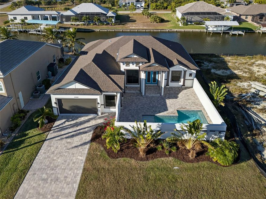 SOUTH GULF COVE! BUILT IN 2024! CUSTOM-BUILT 3 BEDROOM, 2 BATH, 2-CAR GARAGE WATERFRONT POOL HOME WITH SAILBOAT ACCESS TO CHARLOTTE HARBOR LEADING TO THE GULF! 84’ of waterfrontage with concrete seawall and 40’ dock. You’ll be greeted by double door entry into a private courtyard with saltwater pool and pavers to turn into your private oasis. Step inside to contemporary styling featuring high ceilings with tray and custom accents, crown molding, large pocketing slider to water views in great room, private office and luxury vinyl flooring. Modern kitchen features Euopean-style cabinetry, high-end Samsung appliances, leathered granite countertops, subway tile backsplash and casual dining area with huge aquarium window to enjoy panoramic water views. Generous primary suite offers lighted tray ceiling, access to back lanai, large walk-in closet with custom organizers and private bath with dual vanities, custom-tiled walk-in shower. Split floor plan provides privacy for all as guests enjoy their own wing including two bedrooms with walk-in closets and full bath. Spacious back lanai features wood ceiling details and outdoor full outdoor kitchen with granite counters, island with sink, mini-fridge and gas grill with range hood-great space for entertaining guests. Impact windows and roll-down hurricane protection on lanai provide peace of mind. Additional special features include indoor laundry room, tankless hot water heater, solid core custom interior doors, multi-zone irrigation system, epoxy garage floor, impact garage door and exterior with tropical landscaping giving exceptional curb appeal. South Gulf Cove community offers voluntary HOA with clubhouse for special events, four parks nearby including South Gulf Cove Park and Boat Ramp and close to fine dining, shopping, parks, numerous golf courses, boating, and a short drive to Boca Grande and Don Pedro Island beaches. Don’t miss this opportunity! Schedule your private showing today!