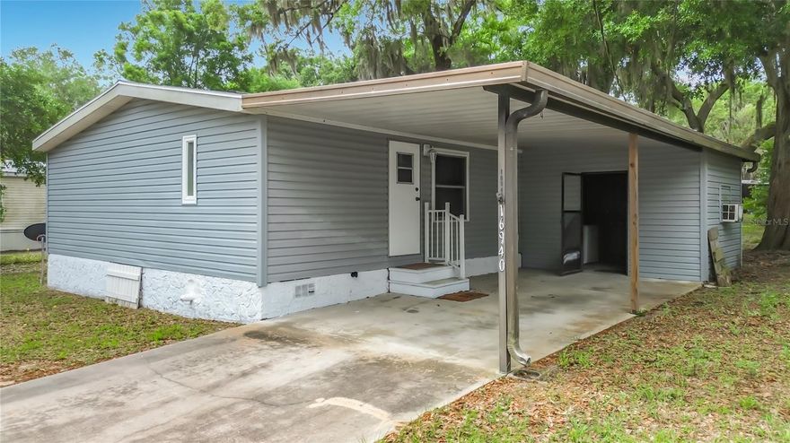 Welcome to this charming and well-maintained 3-bedroom, 2-bath split floor plan manufactured home in the highly desirable Orange Blossom Hills community of Summerfield! Situated on nearly a quarter-acre, this property offers the freedom of NO HOA, NO lot rent, and NO age restrictions—plus no limitations on short-term rentals, making it an excellent option for homeowners, seasonal residents, or investors.

Inside, you’ll find a spacious open floor plan with an eat-in kitchen featuring ample pantry shelving, a cozy wood-burning fireplace in the living room, and updated furnishings in the main living area. The home offers approximately 1,040 square feet of comfortable living space and comes with appliances including washer and dryer. The bedrooms are split, with the master suite in the front of the home and the two bedrooms and second bathroom in the rear.

Recent updates provide peace of mind, including a new roof, new HVAC, updated septic/plumbing improvements, and replaced appliances. The laundry/utility room off the carport includes climate control—perfect for hobbies, workshop space, or additional storage.

Outside, enjoy a large yard with plenty of room to spread out, plus an additional storage shed for tools and yard equipment. Conveniently located just off US 441/27, this home is minutes from The Villages, Lake Weir, shopping, dining, medical facilities, salons, pet groomers, and more—offering the perfect balance of convenience and quiet living.

Move-in ready and packed with value, this centrally located property is a must-see!