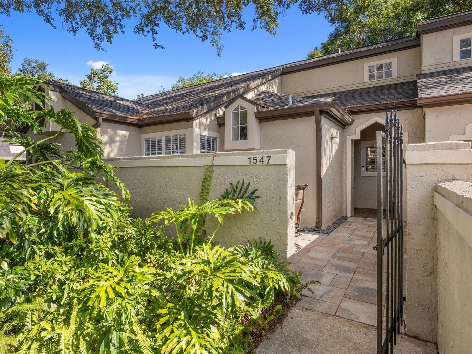 Welcome to 1547 Farrindon Circle, a hidden gem nestled in the desirable Barclay Place at Heathrow—a gated, tree-lined community in the heart of Lake Mary, one of Central Florida’s most sought-after neighborhoods. This beautifully appointed 1-bedroom, 1-bathroom condo offers the perfect balance of elegance, comfort, and convenience, making it an ideal place to call home. As you step inside, you'll immediately notice the warmth and richness of the Brazilian cherry hardwood floors that flow seamlessly throughout the home. The open-concept layout is enhanced by large windows that bring in natural light, creating a bright and airy atmosphere. The living space opens up to a screened-in back patio, offering a peaceful spot to enjoy your morning coffee or unwind after a long day—all while being surrounded by the serenity of lush greenery. In the front, a gated courtyard area offers additional outdoor living space, ideal for welcoming guests or cultivating a small garden oasis. The kitchen is both stylish and functional, featuring beautiful quartz countertops, classic hardwood cabinetry, and a layout perfect for cooking and entertaining. The bathroom mirrors the same level of craftsmanship with a matching hardwood vanity and quality finishes that elevate the everyday routine. Additional peace of mind comes with a new roof installed in 2023, handled by the association—meaning one less thing for you to worry about as a homeowner. Life in Barclay Place means more than just a beautiful home—it’s a lifestyle. The community boasts resort-style amenities including a sparkling pool, spa, tennis courts, and a clubhouse, all set among peaceful walking paths and mature landscaping. Whether you’re enjoying a quiet stroll through the neighborhood, meeting neighbors for a game of tennis, or relaxing poolside, this is the kind of community where every day feels like a retreat. Situated within the Heathrow master-planned area, you’ll have access to nearby Heathrow Country Club and The Legacy Club, where golf, racquetball, and fitness facilities await. For those who love the outdoors, you’re just minutes from scenic nature trails, including the Cross Seminole Trail and Wekiwa Springs State Park, offering hiking, biking, and kayaking adventures. Conveniently located near I-4 and major thoroughfares, this home makes commuting a breeze and places you just minutes from top-rated schools, healthcare, and the best of Lake Mary living. Explore the upscale shops, fine dining, and entertainment options at Colonial TownPark, Park Place, and Historic Downtown Lake Mary. From weekend farmers markets to sunset dinners, everything you love is right around the corner. 1547 Farrindon Circle is a rare find that checks every box. Schedule your private tour today and come experience the charm, comfort, and convenience of life at Barclay Place in Heathrow!
