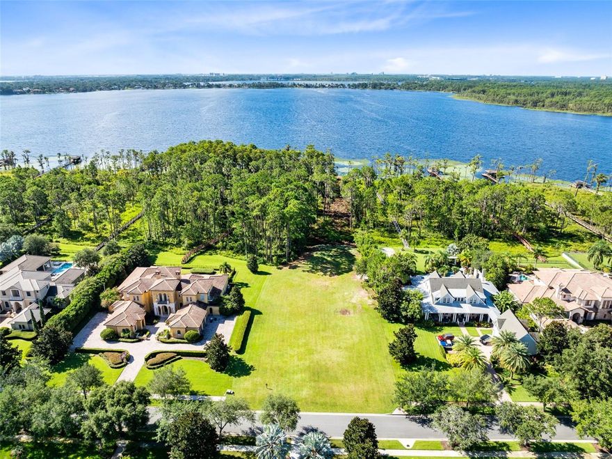Positioned on over two acres with an impressive 136 feet of pristine shoreline on the Butler Chain of Lakes, this exceptional homesite offers an increasingly rare chance to craft a custom lakefront estate in one of Windermere’s most exclusive gated communities. Set within a distinguished enclave of Keene’s Pointe—surrounded by multi-million-dollar residences and mature landscaping—this property captures sweeping views of shimmering Lake Tibet, part of the renowned 13-lake Butler Chain.
One of the final remaining lakefront lots in the community, the site features a wide, level building pad with utilities conveniently located at the property line. A conservation easement enhances the privacy and natural beauty of the setting, while deeded lake access opens the door to an enviable waterfront lifestyle—boating, paddleboarding, and stunning sunset vistas, right from your backyard.
Buyers may select from Keene’s Pointe’s roster of approved luxury builders to design and construct a custom residence tailored to their vision. Imagine constructing your dream and leaving a legacy for future generations. As a resident, enjoy the option to join the Golden Bear Club, with access to a private Jack Nicklaus Signature golf course, tennis, pickleball, resort-style pool, state-of-the-art fitness center, clubhouse dining, and a vibrant calendar of social events.
This is more than a lot—it’s an opportunity to build your dream home on one of Central Florida’s most prestigious lakes. Luxury lakefront living awaits.
