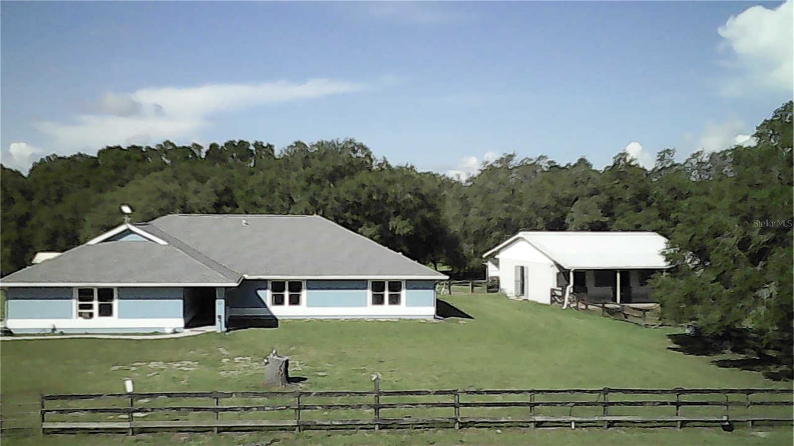 Beautiful 14.91 acre Ranch Retreat with Pool, Barn, and 10 paddocks. Tucked away at the end of a quiet cul-de-sac in a private neighborhood, this beautifully maintained ranch-style home offers over 2100+sq ft of comfort, functionality, and Florida Charm. Located minutes from Dunnellon, Ocala, and the sought after World Equestrian Center. Inside, the home features 3Bed/2Bath, spacious living room and family room. A huge Florida room,ideal for a game room, personal gym, or home office. A wood burning fireplace adds even more charm. Home is wired for a generator for those occasional and scarce power outages. Newer windows throughout the home bring in natural light and energy efficiency. ADT security throughout. Roof is only 4 years old. Eco-conscious buyers will appreciate the solar powered utilities to help reduce monthly bills while keeping the home running efficiently. Step outside to your personal oasis- a heated, screen-enclosed pool with a built in sunshelf and attached hot tub, perfect for unwinding and entertaining year round. The property is fully fenced and cross-fenced, complete with remote controlled gated entrance. Beautiful park like setting throughout. Solid concrete block, 3 stall barn with concrete pad, turn out and wash rack. Plenty of room for all the animals. The barn boasts plenty of room for storage and office space. Additional outbuildings, sheds and carports for your all your needs. Enjoy the serenity of nature with the convenience of being just minutes from town. Don't forget our beautiful Rainbow Springs for a day of kayaking or diving. The property boasts beautiful Oak trees which provides plenty of shade. This rare gem offers the perfect blend of privacy, comfort, and lifestyle. EVERYTHING YOU NEED IS RIGHT HERE. Schedule a tour today.