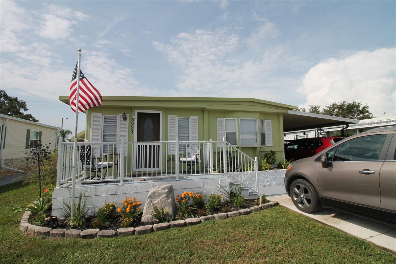 Wonderful and well-maintained mobile home with 3 bedrooms/1.5 bathrooms, a carport, Florida room and large storage shed in the back! Located in Betmar Acres- a quiet 55+ golf community with a LOW HOA fee of $435/ YEAR- you own the land! No lot rent. Inside you'll find an open layout with a spacious living room, an open kitchen and dining area, a HUGE Florida room- perfect for lounging or entertaining- just off the side of the kitchen cooled by a wall ac unit. Large laundry room behind the Florida room- also accessible from the hallway. Community has a multitude of amenities including 2 swimming pools and hot tubs, 3 clubhouses, a library, many walking paths, game rooms and enclosed shuffleboard courts, with 27 holes of golf! Conveniences such as shopping, restaurants, medical facilities, theater, bowling, YMCA, and more- all only minutes away. Water heater replaced in 2023, AC from 2020, Metal roof has no leaks. With some upgrades and personal touches- this can be your perfect retirement home in sunny Zephyrhills, Florida!