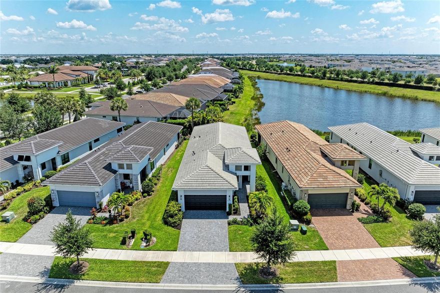 One or more photo(s) has been virtually staged. Imagine starting your day on the lanai with peaceful pond views and Florida wildlife as your backdrop. Wake each morning to a long, unobstructed pond view—one of the more desirable water views in the community. Located in Cresswind Lakewood Ranch, a gated 55+ community, this beautifully maintained Summerland model—one of the most sought-after 2-bedroom floorplans—is freshly painted and move-in ready.

The open layout features luxury vinyl plank flooring (no carpet), upgraded baseboards, and abundant natural light. The kitchen offers white soft-close cabinetry, quartz countertops, tile backsplash, updated hardware, and a large island with pull-outs, single-bowl sink, and built-in waste cabinet, plus pendant, recessed, and under-cabinet lighting.

A den with French doors provides space for an office or guests. The primary suite enjoys pond views and an en-suite bath. Both bathrooms feature ceiling-height tile showers, glass enclosures, upgraded flooring, and soft-close cabinetry.

The screened lanai with clear-view screen overlooks a tranquil pond with frequent wildlife. Additional features include gutters and added electrical outlets.

Maintenance-free living includes lawn care, landscaping, cable, and internet in the HOA.

Cresswind offers a resort-style lifestyle with clubhouse, fitness center, pools, pickleball, tennis, bocce, trails, dog park, and social activities.

Convenient to LWR Main Street, Waterside Place, Siesta Key, Anna Maria Island, and downtown Sarasota, with nearby dining, shopping, golf, and medical facilities.

Move-in ready with one of the better water views in the community.