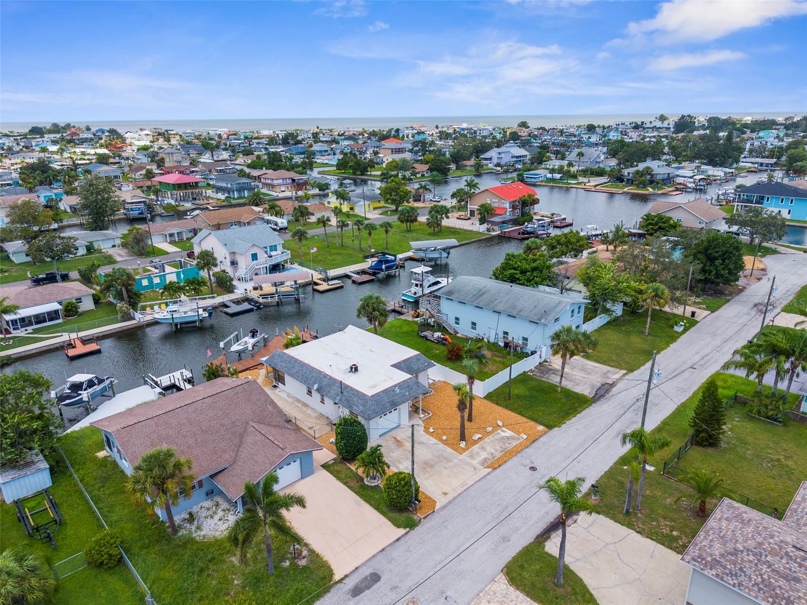 Welcome to effortless Florida living, with 368 sq ft bonus under air. (Not included in heated square footage)This renovated waterfront home features a private dock with boat lift, giving you direct access to the Gulf of Mexico with around 10 minutes of idle time. Both bedrooms have en-suite bathrooms, making this a great rental option. The low-maintenance, zero-scape landscaping means no yard work — just more time to enjoy the water, the sunshine, and the lifestyle you’ve been craving. Inside, you’ll find a bright, open layout with updated finishes and gorgeous water views from the main living areas. Whether you’re sipping coffee on the patio at sunrise or heading out for a sunset cruise, every day here feels like a vacation. Hudson Beach offers a golf cart neighborhood which restuarants, entertainment, and an ice cream parlor all without leaving the neighborhood.