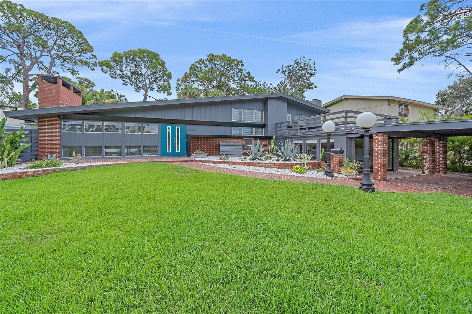 **Priced below recently appraised value** Designed by the famed architect, Glen Q. Johnson, this Mid-Century Modern Bird Cage Home is one of only 13 unique homes built in the area. Known for his work in designing the St Pete Beach Library, the North Shore Aquatic Center, and the Pinellas County Judicial Building, Glen Q. Johnson, designed these “Vision-Aire” homes to provide comfort in the tropical Florida weather. Each home featured a unique floor plan and were oriented to the Southeast in order to best catch the breezes from nearby waterways. The Birdcage nickname comes from the floor-to-roofline screened terraces providing the ultimate amount of comfort and style while enjoying the Florida weather. The home itself has been tastefully updated while taking careful consideration to preserve the original design and “feel” of the home. This particular home features 3 bedrooms, 2 bathrooms and 1869 square feet of heated/cooled living space. The main living area features beautifully restored terrazzo floors, a wood burning fireplace, and a completely redone modern kitchen all overlooking the massive outdoor patio space, outdoor kitchen, and beautiful saltwater pool. The primary is located on the second floor and has access out to the refinished private deck. The downstairs suite features a kitchenette, own private entrance, and independent mini-split air conditioning units making it the perfect guest suite, in-law suite, or vacation rental. An additional bonus room provides even more flexibility for those looking for an office space or workout room. Outside the home you are greeted by a gorgeous private oasis featuring mature landscaping, a saltwater pool with pavers, a free standing fountain and multiple covered seating areas. Providing further peace of mind is the new roof in 2023, new HVAC in 2024, and new water heater in 2024. Located in close proximity to downtown Saint Petersburg, world renowned Florida beaches, local boat ramps, parks, and much more, this unique home is surely a dream come true.