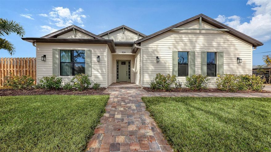 Located in the desirable Southgate neighborhood, this custom new build blends an organic modern design with lovely coastal touches. Created for both comfort and versatility, the 2,372 sq. ft. floor plan of open-concept living features 3 bedrooms plus a flexible bonus room, ideal as a home office, den, or creative space. The home includes 2 full bathrooms and an elegant powder room. The designer fixtures and finishes have been expertly done with a minimalist aesthetic that is both stylish and highly functional. Pops of color enhance the warm neutral interior, creating a timeless and sophisticated appeal throughout. A stunning gallery-style foyer welcomes you with classic wainscoting and a skylight that fills the entry with natural light. The impressive great room features a dramatic 12’ 8” ceiling accented by striking wood beams, creating a grand yet inviting gathering space. The kitchen is a true centerpiece, showcasing an all-white palette, standalone range hood, expansive quartz island, and a well-sized butler’s pantry featuring a wall of gorgeous cabinetry, a dishwasher, and convenient pass-through access to the kitchen. The adjoining dining area is surrounded by three large windows and offers direct access to the covered patio, creating a wonderful setting for indoor-outdoor entertaining and al fresco dining. The primary suite offers an enchanting retreat, complete with a double vanity flanked by illuminated niches, a large frameless glass shower with walls of exquisite tile, artistically wallpapered water closet, a mirrored wall above the vanity, and rich gold -colored fixtures. Massive 10-ft. tall French doors enhance the home’s light-filled atmosphere while opening to a covered lanai and private, tropically landscaped yard. Additional highlights include grid-less windows that enhance the seamless indoor-outdoor feel, thick luxury vinyl plank flooring throughout, a spacious two-car garage, and a tiled outdoor shower. The fabulous in-town location places you just moments from an array of arts and entertainment venues, along with abundant recreational, shopping, and dining opportunities. The home is also located within one of the area’s most sought-after school districts, known for its strong academic excellence. With its spectacular design elements and beautiful architectural details, this residence creates an atmosphere where you’ll want to simply relax, unwind, and savor the beautiful surroundings. It’s a place where you and your family can live the perfect Sarasota lifestyle along one of Florida’s most picturesque coastlines.