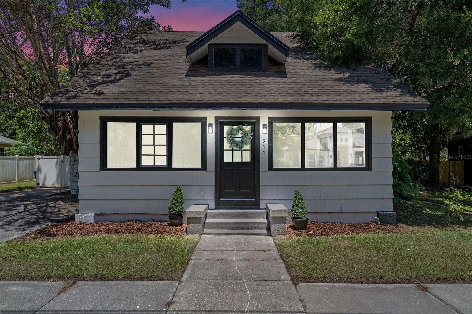 This beautifully remodeled 1930 American Craftsman Bungalow has been thoughtfully updated from top to bottom and is located in the heart of the Golf Cart District in Downtown Sanford. Major upgrades include a brand-new HVAC system, many modern updates including kitchen and all three bathrooms, features a 2018 roof, and a fully resurfaced in-ground pool with a freshly painted deck and brand-new pool pump. The entire home features new luxury vinyl plank flooring, updated lighting, and fresh interior paint and texture throughout.
Offering four bedrooms and three bathrooms (two full and one half), the layout is both functional and stylish. The half bath is conveniently located near the back entrance for easy access from the pool. The open-concept kitchen has been completely renovated with soft-close white shaker cabinets, quartz countertops, stainless steel appliances, open wood shelving, a sleek vent hood, and modern fixtures. A spacious living/dining area lined with windows flows seamlessly into the open back porch, creating the ideal setting for entertaining or relaxing.
The updated bathrooms include a newly tiled walk-in shower with a sliding glass door in the primary suite, new vanities, toilets, and upgraded fixtures. Outside, enjoy a fully fenced backyard with white vinyl privacy fencing, mature trees, and ample patio space around the pool, including a separate screened in porch area.
Just minutes from Sanford’s vibrant downtown scene, the Riverwalk, parks, shops, and restaurants. Don’t miss this rare opportunity to own a piece of Sanford’s history, beautifully restored and move-in ready.
