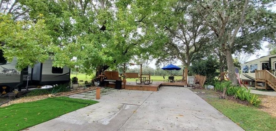 Looking for a LUXURY RV Lot to BUY in FLORIDA?  Look no further!  Full Privacy at this River Ranch Lot in Central Florida! 
Rent the Lot out while not using and pay for expenses!  WELCOME TO RIVER RANCH RV RESORT, Florida’s Luxury RV Resort with access to Lake Kissimmee! NO REAR NEIGHBORS AND GORGEOUS VIEWS from this privately owned RV Lot located in Phase 2!  If you like Deer watching, this Lot is for you!! Extended room for firepits, cornhole, football and more!  This property offers GORGEOUS landscaping, a deck, shade tree and built in seating! EZ in EZ out with your RV!   This lot has an extended concrete patio with room for outdoor kitchen space, additional tables and seating areas and an area for a storage shed. This lot offers shade and sun - the perfect combination! Big Rig Friendly!  
Looking for entertainment and fun? River Ranch offers it here!! For starters, there is a LIVE Rodeo every Saturday night – an excellent display of showmanship and fun for the entire family! There is even a Saloon (family friendly), with LIVE bands, DJs, dance parties and they give line dancing lessons for free. There is a waterpark, an adventure park which has a bounce house, mechanical bull, climbing tower, Arcade, mini golf, outside movie on the greens, bicycle rentals, airboat rides, river boat rides, swamp buggy, hayrides, petting farm, trap & skeet range and a bow target for shooting. There are several places to eat on property. The River Ranch Chop House serves delicious food and drinks, a waterfront Smokehouse Grill serving delicious BBQ, a pizza shop and an ice cream and coffee shop (serving Starbucks.) There is also a General store and a Western store to grab all of your favorite Cowboy/Cowgirl finds! Watch the Bison, Steers, Horses and other wildlife! Don’t forget to check out the Petting Farm!!