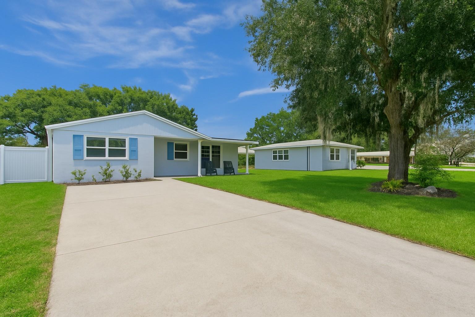 Stylish and solidly built, this 3-bedroom, 2-bath home offers 1,305 sq ft of thoughtfully designed living space. Constructed with 9" concrete walls, wrapped in Tyvek, and finished with maintenance-free vinyl siding, this home is as durable as it is attractive. The roof—built with all-plywood decking and dimensional shingles—is only 4.5 years old. Enjoy Florida living with a private concrete pool featuring a new pump and skimmer, a sprawling wood deck, and a fully fenced backyard ideal for entertaining. Inside, you'll find cathedral ceilings, recessed lighting, new plush carpeting in two bedrooms, and elegant ceramic tile throughout the rest of the home. The kitchen features warm oak cabinetry, a raised dining room, and an oversized living area filled with natural light. A detached utility building with electric and shelving adds versatility. Located just 1 mile from charming downtown New Port Richey—an area quickly emerging as the next Dunedin.