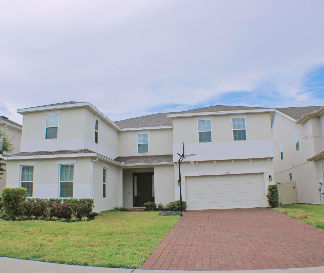 Luxury Living in the Heart of Clermont! This stunning 6-bedroom, 4.5-bathroom home at 7653 Modica St offers an unparalleled blend of elegance, space, and modern convenience. Perfectly situated for easy access to all of the attractions without feeling touristy, this property is a tranquil retreat just a 20-minute drive from the enchantment of Magic Kingdom. Step inside and be captivated by over $100,000 in designer upgrades, including a neutral color scheme that provides a timeless and sophisticated backdrop for any style. The first floor boasts an impressive 9'6" ceiling height, enhancing the open and airy feel of the home. Elegant designer tile flooring flows throughout the entire first floor, adding a touch of luxury and durability. The main living areas are expansive, featuring two great rooms and a flexible bonus room that can be used as an office, home gym, or media center. The gourmet kitchen is a chef's dream, boasting top-of-the-line appliances, including double ovens, and ample counter space for preparing meals and entertaining guests. For ultimate privacy and convenience, the first floor features a dedicated guest suite with a private entrance, an ensuite bathroom, and a wet bar—perfect for hosting visitors or using as a private in-law suite. The home faces east, providing beautiful morning light. A huge, fenced yard offers a private oasis for outdoor activities and relaxation. Additional features include: * Ceiling fans in every room for comfort and energy efficiency. * Pre-wired for pool equipment, making it easy to add a future pool. This home is a true gem, combining luxurious upgrades, a prime location, and thoughtful design. Don't miss the opportunity to own this exceptional property!