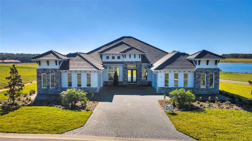 A rare blend of privacy, elegance, and effortless modern living, without the wait. Welcome to The Monica by ICI Homes, a showcase of architectural grace and thoughtful craftsmanship. Set on more than half an acre in the exclusive gated enclave of West Hills Estates, this single-story residence spans nearly 3,500 square feet and embodies the art of refined Florida living: spacious, sunlit, and serenely private. Beyond its stately elevation and four-car garage, every detail has been curated for those who appreciate both beauty and purpose. Inside, the grand foyer opens to formal and flexible spaces, an elegant dining room for memorable gatherings and a study that invites quiet reflection or inspired work-from-home moments. The heart of the home unfolds in an expansive open layout where the living area, kitchen, and breakfast nook flow effortlessly together. Double sliding glass doors blur the line between indoors and out, filling the home with natural light and tranquil views. The chef’s kitchen is a masterpiece of function and style, featuring soft-close cabinetry, premium stainless steel appliances, a walk-in pantry, and generous counter space that makes entertaining a joy. The primary suite is a private sanctuary with dual walk-in closets and a spa-inspired bath complete with dual vanities, a soaking tub, and an oversized walk-in shower. Three additional bedrooms are thoughtfully positioned for comfort and privacy, each with its own or nearby bath, ideal for family or guests. Nestled amid the rolling hills and pastoral beauty of Dade City, West Hills Estates offers the peaceful charm of Old Florida living while keeping you close to the conveniences of Wesley Chapel, Tampa, and major thoroughfares. Here, the sounds of nature replace city noise, and every sunset feels like a private escape. Discover a life of space, serenity, and sophistication - your new custom home awaits in West Hills Estates.