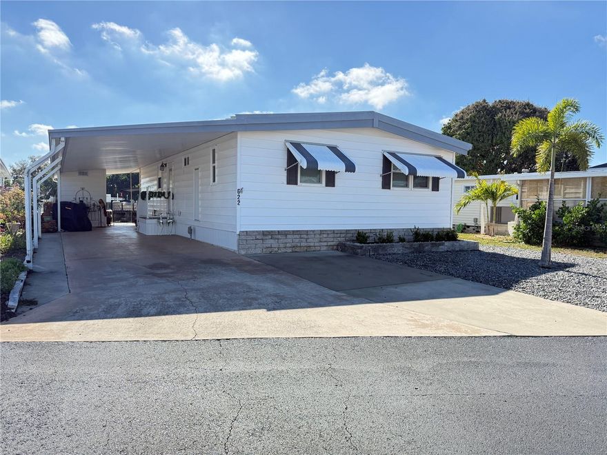 This well-maintained 2 bedroom/ 2 Bath home offers bright and open living space.  Large windows provide natural light while showcasing the beautiful waterfront setting just outside your door.  This home with 1032 Sq Ft has been remodeled and presents an open concept combining the kitchen, dining and family rooms, great for everyday or entertaining guests.  The kitchen has plenty of solid wood cabinets, Quartz countertops, Hi-top bar, and eating area.  The large master bedroom has walk in closet, master bath with walk in shower, and updated vanity.  New luxury vinyl throughout (2025) updated windows, and all new plumbing.  Three Mini Splits provide quiet and efficient heat and AC, low utility bills, eliminating floor vents and AC ducts below.  New Sub Floor and Foam Vapor Barrier provide added protection below.  Enclosed 210 sq ft lanai has NO-SEE-UM screens and removable vinyl windows, waterproof vinyl flooring, and is a great place to relax and enjoy the privacy of your waterfront home.  Beautiful walkway leading to your dock and boat lift, and also has a jet ski lift or can be used to store kayaks for easy access to the water.  The carport has expanded posts for more room and can accommodate 2-4 vehicles, including a golfcart.  Price includes the share for the lot and ownership in the community.  Americana Cove is a 55+ resident owned community, close to downtown St Pete, 15 min to 2 airports, and 20 minutes to the beaches.  HOA $380 includes water, sewer, lawn mowing, trash pick up, 24-hr manned gate, heated pool, shuffle board, bocce, 2 boat ramps, and many clubs and activities.  Make an appointment today to see this beautiful home.