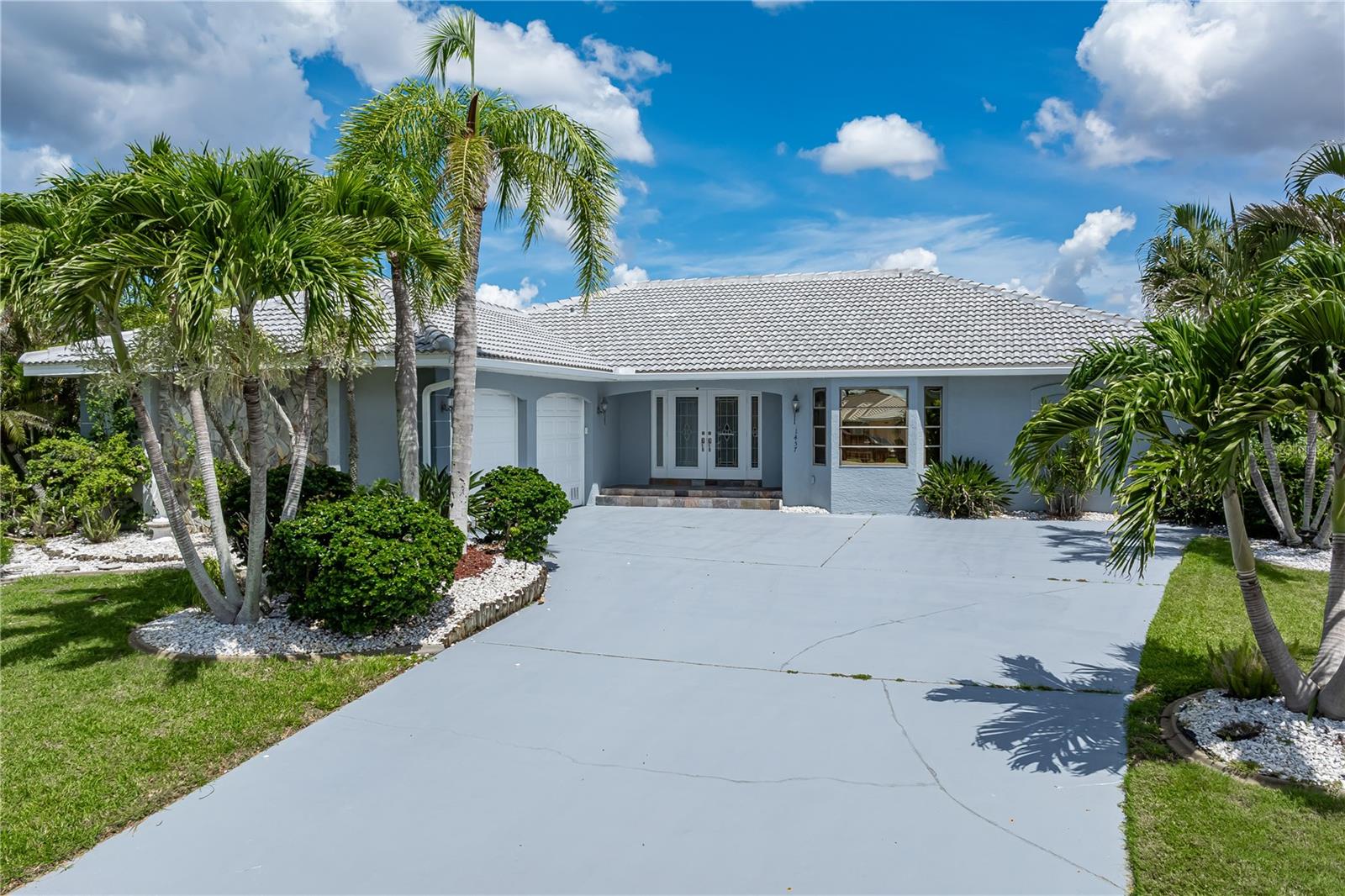 One or more photo(s) has been virtually staged. PGI WATERFRONT HOME ON TIP LOT WITH 173FT OF SEAWALL, INTERSECTING CANAL VIEWS & **NEW ROOF**- Situated on an oversized, tip lot in Punta Gorda Isles, this 3 bed/2 bath waterfront pool home delivers exceptional sailboat access to Charlotte Harbor in minutes via Buckley’s Pass or Ponce Outlet. Boasting 173 feet of city-maintained seawall, a wide turning basin, and intersecting canal views, this home offers the ultimate boating lifestyle from your backyard. Inside, the home features a bright and welcoming layout with fresh neutral finishes and thoughtful upgrades. The heart of the home—a recently updated kitchen—offers granite countertops, all-white cabinetry, LED lighting, and a versatile, mobile center island. The spacious great room flows seamlessly to the lanai through disappearing sliding glass doors, creating a spacious indoor/outdoor connection. The split-bedroom floor plan ensures privacy for owners and guests alike. The generous master suite includes walk-out access to the lanai, two picture windows framing the water view, a walk-in closet, and an en-suite bath with dual sinks, a garden tub, and a separate shower. Both guest bedrooms are comfortably sized with walk-in closets; one guest suite has direct access to the pool and shares a beautifully remodeled guest bath with dual sinks and a walk-in tiled shower. Step outside to the screened lanai that includes an in-ground pool surrounded by covered seating area that is perfect for al fresco dining or catching gorgeous sunset views. A concrete dock awaits your boat just steps from the home. Thanks to the extended wraparound seawall, the location of the dock does not compromise the fantastic view. There's plenty of room to add a 2nd dock & still not affect the view. Additional features include a brand-new roof (2024), new A/C system (2022), attic insulation, upgraded ceiling fans and light fixtures, fresh living room carpet, and a full-size laundry room with utility sink and newer washer/dryer. Hot tub hookup added - ready for hot tub if buyer so desires. The side-facing oversized two-car garage offers a storage bump-out for your tools or gear. Located just minutes from St. Andrews South Golf Club, Isles Yacht Club, Fishermen’s Village, and historic downtown Punta Gorda, this home combines the best of boating, golfing, and dining. Enjoy SW Florida’s year-round sunshine and coastal lifestyle from one of the finest waterfront properties on the market. Boat is for sale separately.
