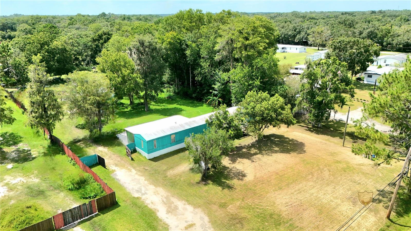 Charming 3 bedrooms 2 bathrooms manufactured home situated on spacious 1.25-acre property (54,635 sq ft) offering privacy and quiet atmosphere. Perfect for those seeking NO HOA with plenty of natural space and with a R-T 2 zoning. This well-maintained home features open concept with tile flooring throughout. The master suite boast an ensuite bathroom with separate shower and a garden tub for added comfort and relaxation. Two additional bedrooms offers ample space for family members or guests with dual closets for plenty of storage.
Enjoy outdoor living in the enclosed, screened-in back porch (21x9) overlooking your expansive, fenced-in lot with double gate access—plenty of room for boats, RVs, or recreational toys. Plenty of room to breath and enjoy gardening and enjoy the fruits of the already planted trees. The home runs on well and septic, the roof has been resealed in 2021. Convenience location at just minutes from Avalon Park. and all the schools are located within few miles of distance at just 5.2 miles from the high school, 4.8 miles to the middle school, and 14 miles to the elementary school.
Don’t miss this opportunity to own a slice of Florida freedom!