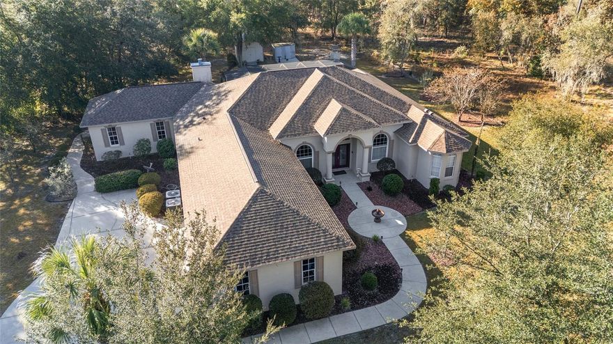 Expansive Rainbow Springs estate on double lot with pool, game room and community Rainbow River access. Welcome to a rare opportunity in the heart of Rainbow Springs Country Club, The Forest Section, where lifestyle, space and sophistication converge. On a desired double lot, this impressive four-bedroom, three-bath residence spans over 3,100 square feet and offers the kind of privacy, scale and amenities discerning buyers seek. The moment you arrive, you'll appreciate the large extended driveway, and sense of space that only a double lot can provide. Inside, soaring coffered ceilings, elegant crown molding, and expansive living areas set the tone for refined yet relaxed living. The chef’s kitchen features granite countertops, updated appliances and abundant storage, while the oversized primary suite offers a spa-like bath with garden tub, walk-in shower and dual vanities. A standout is the massive bonus room, ideal as a trophy room, game room, home theater or multi-generational suite. Whether you're entertaining or unwinding, the screened saltwater pool with new heater, chlorinator, and pump invites year-round enjoyment. The outdoor kitchen and grill area make alfresco dining effortless. Recent updates include 2021 roof, updated windows and new irrigation control system. As a resident of Rainbow Springs Country Club, you’ll enjoy access to a full suite of amenities such as a clubhouse with restaurant and bar, tennis and pickleball courts, fitness center, community pool and private owners-only beach on the Rainbow River, ideal for kayaking, swimming or simply soaking in the natural beauty. This is more than a home, it’s a lifestyle. With acreage-style breathing room, resort-level amenities and a prime location just minutes from downtown Dunnellon, this property is ideal for those seeking elegance, elbow room and everyday adventure.