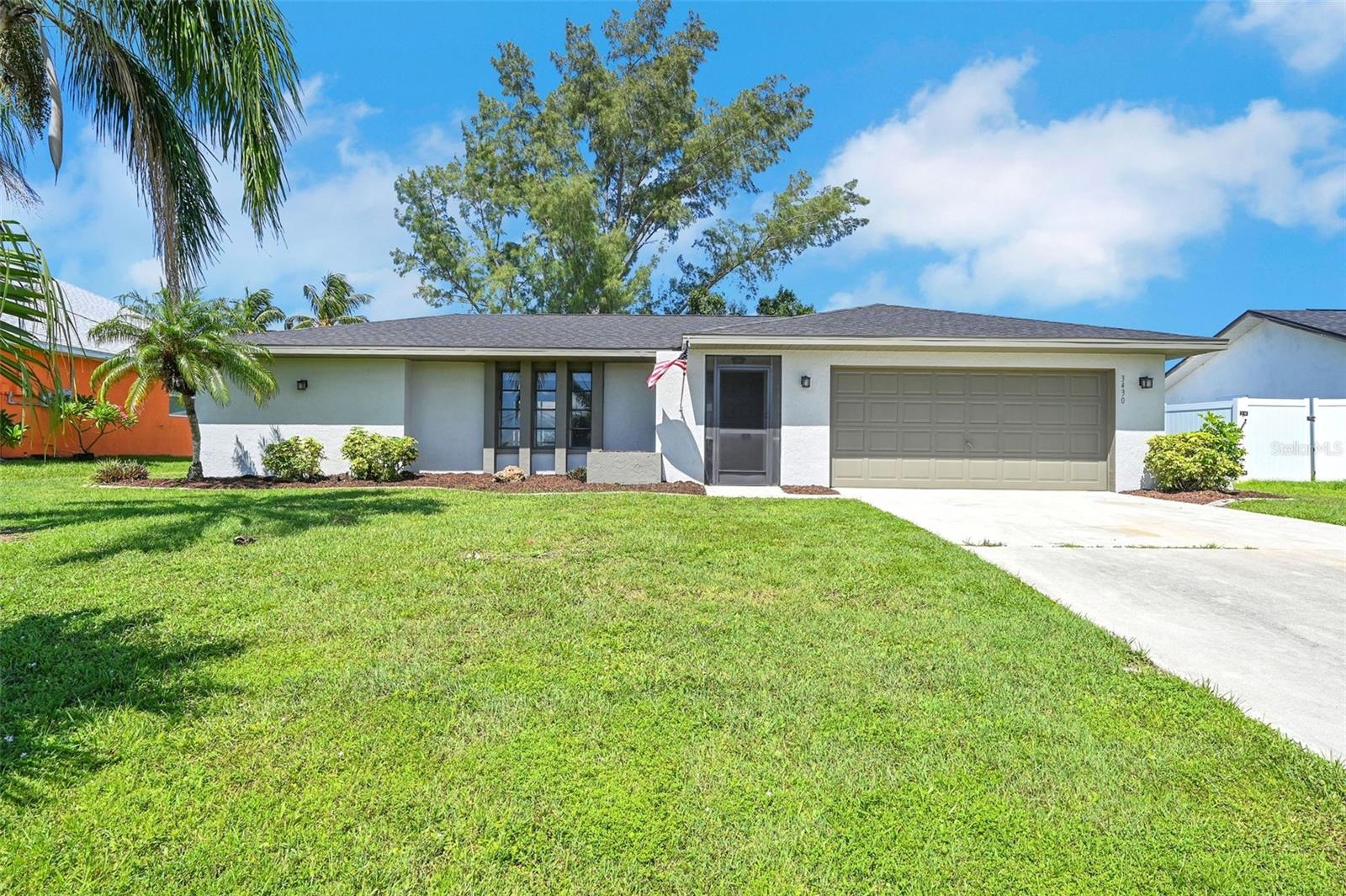 Centrally located just blocks from all of your daily shopping needs, and great dining options, you'll find this SW Cape Coral Ranch. A lush green lawn and great curb appeal are the immediate attention grabbers here. You'll appreciate a freshly painted exterior, fully fenced back yard and low maintenance landscaping. Head inside to a bright and welcoming split floor plan. Light tile, white trim and soft gray paint give this home a sunny disposition. A spacious living and dining area are perfect for entertaining and you can move the gathering outside to the screen porch if you'd like to spread out. An updated kitchen and sleek appliances give the home a touch of contemporary flare with an exceptional amount of counter space as well as an abundance of cabinetry. A breakfast bar adds the perfect touch and brings the full living area together. The owners suite is complete with 3/4 ensuite bath and outstanding walk-in closet, you are going to love the privacy and comfort of this design. Two additional bedrooms each have their own spacious walk-in closets. A full bath is easily accessed from the 2 bedrooms or the screened porch for your convenience. You'll check the last box of your must have list with the 2 stall garage. Welcome Home!