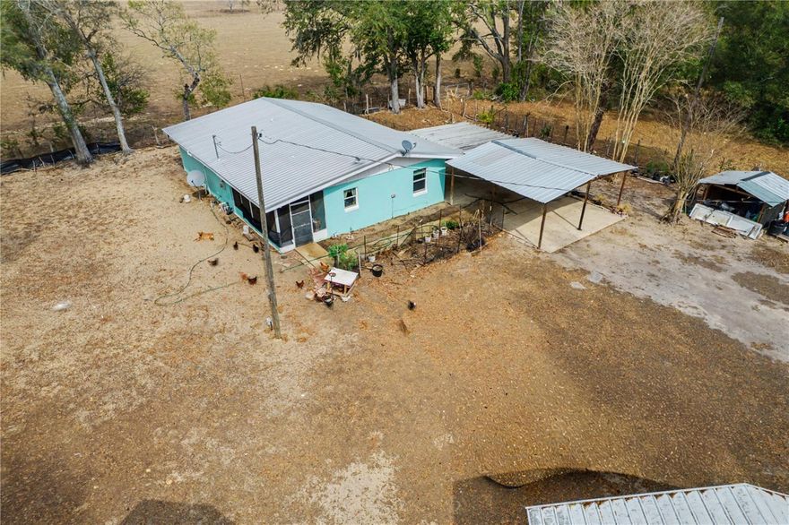 Enjoy rural living on nearly one acre with this concrete block home offering a functional layout and valuable outdoor improvements. This 3-bedroom, 1-bath residence includes a flexible office space that can serve as an additional bedroom or workspace. Recent updates include a 2022 metal roof, newer A/C system, newer septic tank, newer water heater, and remodeled kitchen and bathroom completed in 2022.

The property features two steel outbuildings: a 20×30 workshop with electric service and a 14×30 air-conditioned building with its own breaker panel, providing excellent utility for storage, hobbies, or equipment. A two-car carport offers covered parking, and the backyard overlooks open farmland for added privacy and a natural setting.

Located in a quiet rural area with no HOA and convenient access to Williston, Gainesville, and Ocala.