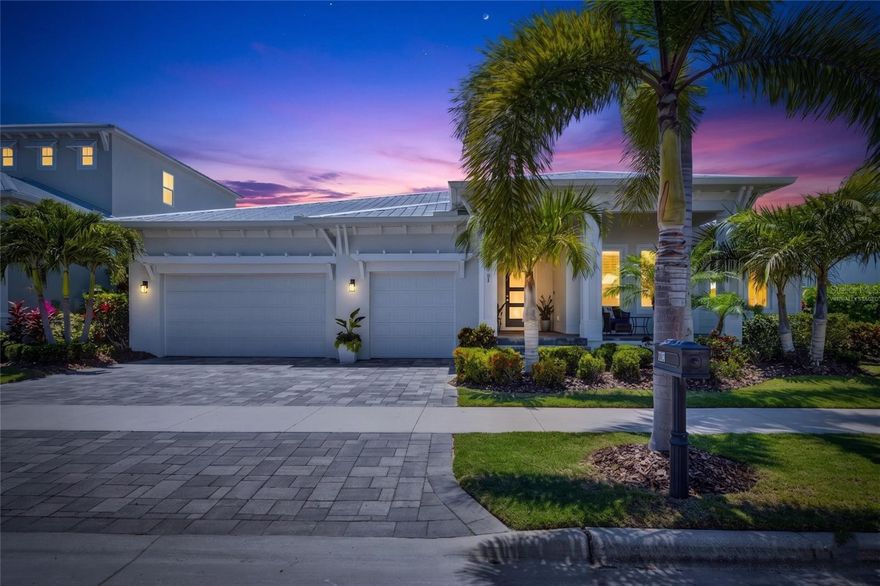 One or more photo(s) has been virtually staged. 5704 Tybee Island Drive | 4 Bedrooms | 3 Bathrooms | 2733 Sq ft | Waterfront Pool Home | MiraBay
Experience luxury waterfront living in the gated coastal community of MiraBay in Apollo Beach, Florida. This custom, one-of-a-kind Key West-style pool home offers direct saltwater canal frontage with quick access to Tampa Bay and no fixed bridges, creating the ideal setup for boating, paddleboarding, kayaking, and enjoying the Florida waterfront lifestyle. Built by Bistro Builders and completed in 2022, this meticulously maintained one-story residence combines modern coastal design, functional living space, and resort-style community amenities.

Positioned on a landscaped homesite with approximately 80 feet of saltwater canal frontage, the property features a private dock and lift, a seawall, and an in-ground pool overlooking the water. The exterior is enhanced by professional uplighting in the front and back of the home, a lighted dock, and retaining wall lighting. The covered outdoor living area and the front of the home feature elegant wood ceilings, while the outdoor kitchen is finished with sophisticated waterfall edge countertops. Providing significant peace of mind, the metal roof, HVAC system, and tankless water heater are all 5 years old, and the home features foam insulation for maximum efficiency. The extensive 3+ car garage provides built-in storage and additional space for golf carts, water toys, or workshop needs.

Inside, the open-concept floor plan offers approximately 2,733 square feet of heated living space with soaring 12-foot ceilings, crown molding, tray ceilings, and abundant natural light. The home is equipped with a whole-home audio system, including speakers in the ceilings throughout a majority of the home and the outside lanai. The chef-inspired kitchen features quartz waterfall edge countertops, stainless steel appliances, a built-in oven, and a cooktop. This dream kitchen is upgraded with an extra-large walk-in pantry, a built-in butler's pantry, and a wine bar, all anchored by an oversized breakfast bar ideal for entertaining.

The primary suite is positioned privately at the rear of the home with peaceful canal views and a custom California closet. The spa-style ensuite primary bathroom is a true showpiece, featuring a walk-through shower with floor-to-ceiling imported tile and multiple shower heads, dual sinks, a soaking tub, and stone countertops. The thoughtfully designed split bedroom layout ensures privacy, featuring private guest suite with its own ensuite bath and large closet and two secondary bedrooms sharing a full bathroom on one side of the home. A dedicated office provides additional flexibility for remote work or a home gym.

Additional upgrades and features include a whole-home water softener, Honeywell security system, central air, fiber internet capability, natural gas connection, ceramic tile flooring throughout the main living areas, and fresh interior paint in Sherwin Williams Evening Shadow.

Residents of MiraBay enjoy access to exceptional resort-style amenities including a clubhouse, café, fitness center, heated community pools with a waterslide, tennis, basketball, and pickleball courts, parks, playgrounds, and community boat ramps. Conveniently located near Tampa, St. Petersburg, Sarasota, and major commuter routes, this Apollo Beach waterfront home offers an unmatched blend of luxury, boating access, and coastal Florida living.