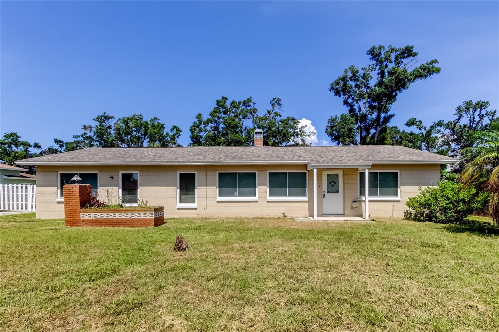 Huge 0.45 Acre lot in prime location in Town & County at Sweetwater Estates. This home includes 4 bedrooms and 2 baths and has many updates. Upon entering there are luxury vinyl plank floors for a seamless look. The living room is spacious and includes a fireplace. In the kitchen you will find white cabinets, a unique built in grill, and space for an eat in kitchen. To the left there is a formal dining room or bonus space, use however you see fit with new sliding glass doors. From there you will enter the primary bedroom with its own en-suite bath that includes a walk in shower. The other 3 bedrooms have great closets and plenty of natural light. Outside the sliders you will find a screened in lanai to enjoy our Florida weather and just outside is a laundry room with a washer included. The huge lot is fenced in and includes a storage shed. Newer windows and the roof was installed in 2016 so plenty of life left. No HOA. Call today for a private tour!
