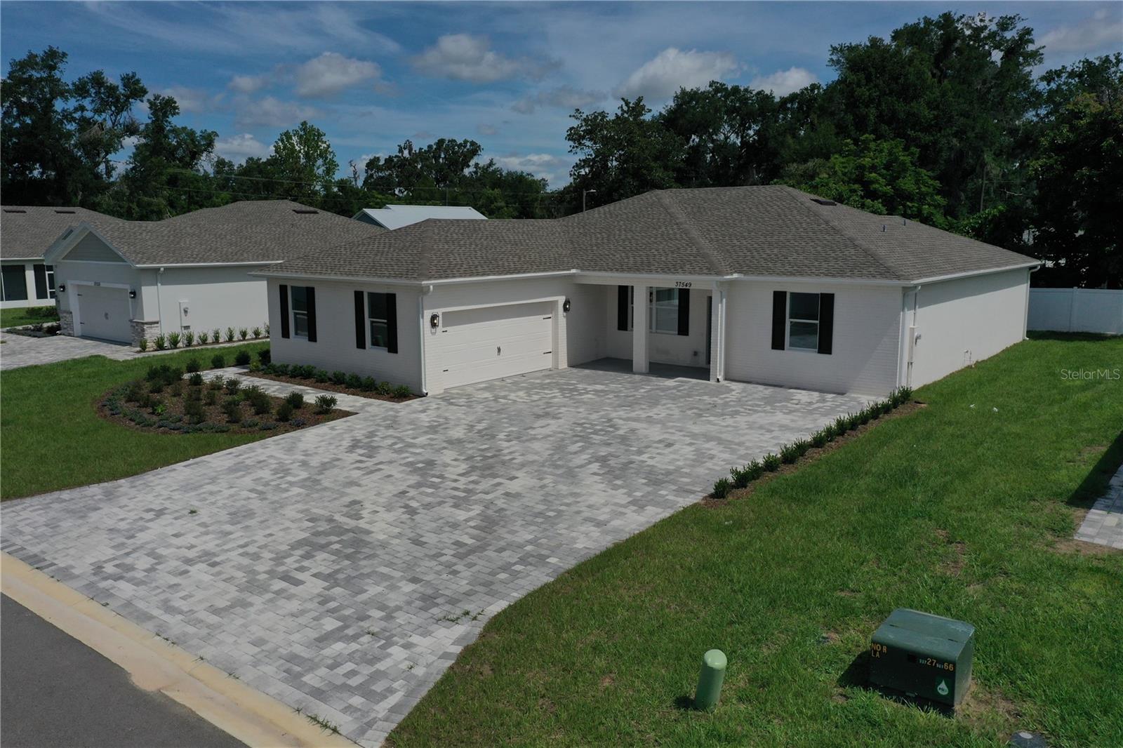 One or more photo(s) has been virtually staged. Stunning Custom-Built 4 Bedroom 3 Bathroom New Construction Home with UPGRADES, UPGRADES, UPGRADES!
Step into luxury with this beautifully designed custom-built new construction home featuring 4 spacious bedrooms, 3 full bathrooms and an oversized parking pad with custom pavers (large enough for 4 plus vehicles) complete with a dedicated storage room in your spacious garage. This immaculate residence combines modern finishes with thoughtful upgrades throughout, offering both style and functionality.
**Interior Highlights**
Gourmet Kitchen: Enjoy cooking in your upgraded chef’s kitchen with custom wood cabinetry, sleek stainless steel appliances, sparkling quartz countertops, and an eye-catching tile backsplash.
Spacious Living Areas: Open-concept layout perfect for entertaining or relaxing with family, accented by high ceilings and abundant natural light.
Designer Bathrooms: All bathrooms feature elegant tile work, quartz countertops, upgraded fixtures, and modern vanities—including a luxurious double-sink vanity in the primary bath and jack-n-jill bathroom. In addition, the 2nd bathroom is located directly outside the 2nd bedroom giving it an ensuite feel!
Premium Flooring: Beautiful, durable wood-look tile flooring runs throughout, enhancing the home’s warm, cohesive feel.
**Garage & Storage**
The spacious garage offers ample space for vehicles, tools, and recreational gear—plus a bonus storage room to keep everything organized.
**Location & Community**
Perfectly situated within the city limits of beautiful, historic downtown Dade City on a private cul-da-sac road with only 6 homes total in this community. This home is close to schools, parks, and shopping, with easy access to major roads for commuting into Tampa.
Don’t miss your chance to own this move-in ready, high-end new build that checks every box!