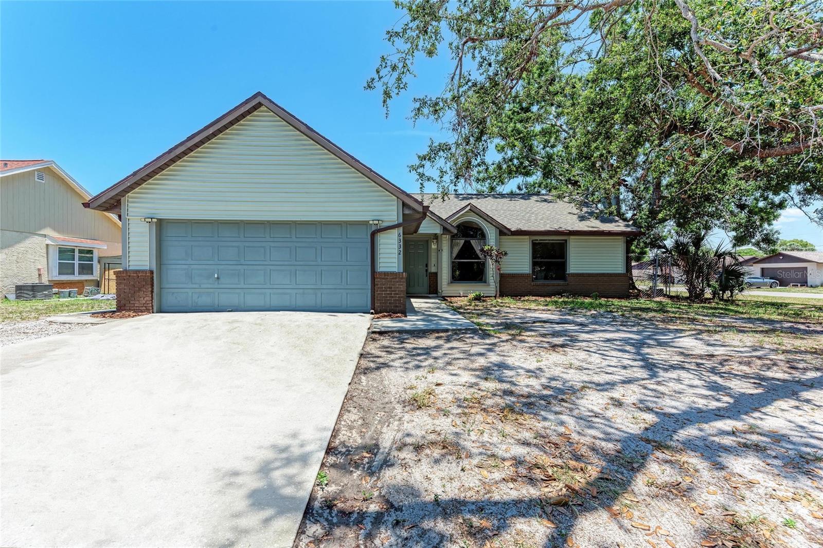 Welcome to this beautifully updated three-bedroom, two-bath home with a newer roof, perfect for families and those looking to establish roots. The bathrooms have been tastefully updated, adding a modern touch to this charming residence. Situated on almost a third of an acre, this property offers plenty of space to grow, with a generous fenced-in backyard providing both privacy and security for children and pets. The great lanai area is an inviting space for outdoor relaxation and entertaining, making it ideal for gatherings with friends and family. The oversized two-car garage adds convenience and ample storage for your vehicles and outdoor equipment. Located just minutes from restaurants, shopping, and the world’s most beautiful beaches, this home is competitively priced and won’t last long on the market. Don’t miss out on this fantastic opportunity to make it your own!