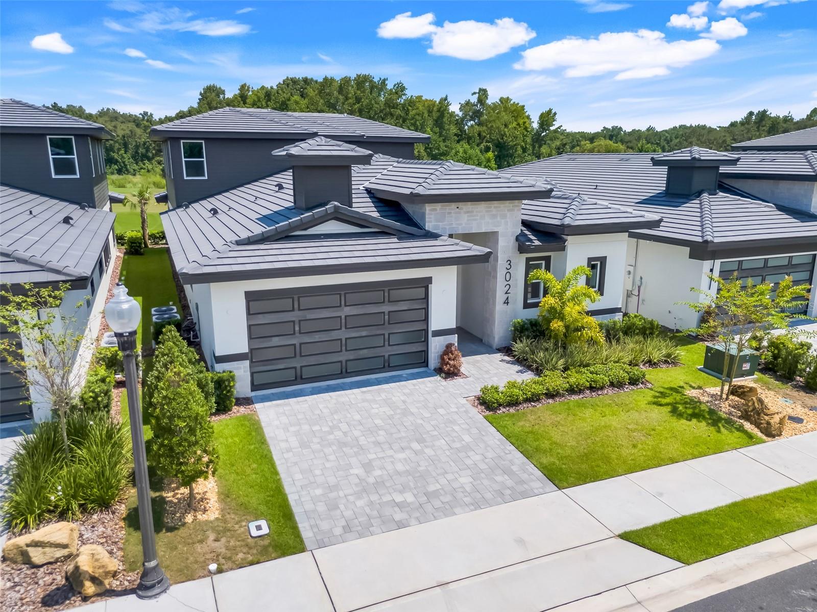 The Courtyard 50 by ABD Development in Hampton Green at Providence - this completed show home is a work of art! Located directly on the 11th hole of Providence Golf Club, this courtyard home is ideal for indoor/outdoor living. Contemporary finishes abound in this newly completed inventory model. Enjoy the privacy of the courtyard pool, and your own separate pool house! Outstanding features include a gourment kitchen, downstairs master bedroom, and a beautiful balcony overlooking the golf course! Hurry - the house next door just sold. This one will not last and the next few of this model to be built will see a big price increase. Take advantage! Move-in READY!
Note - photos are of the exact same floor plan home located next door.